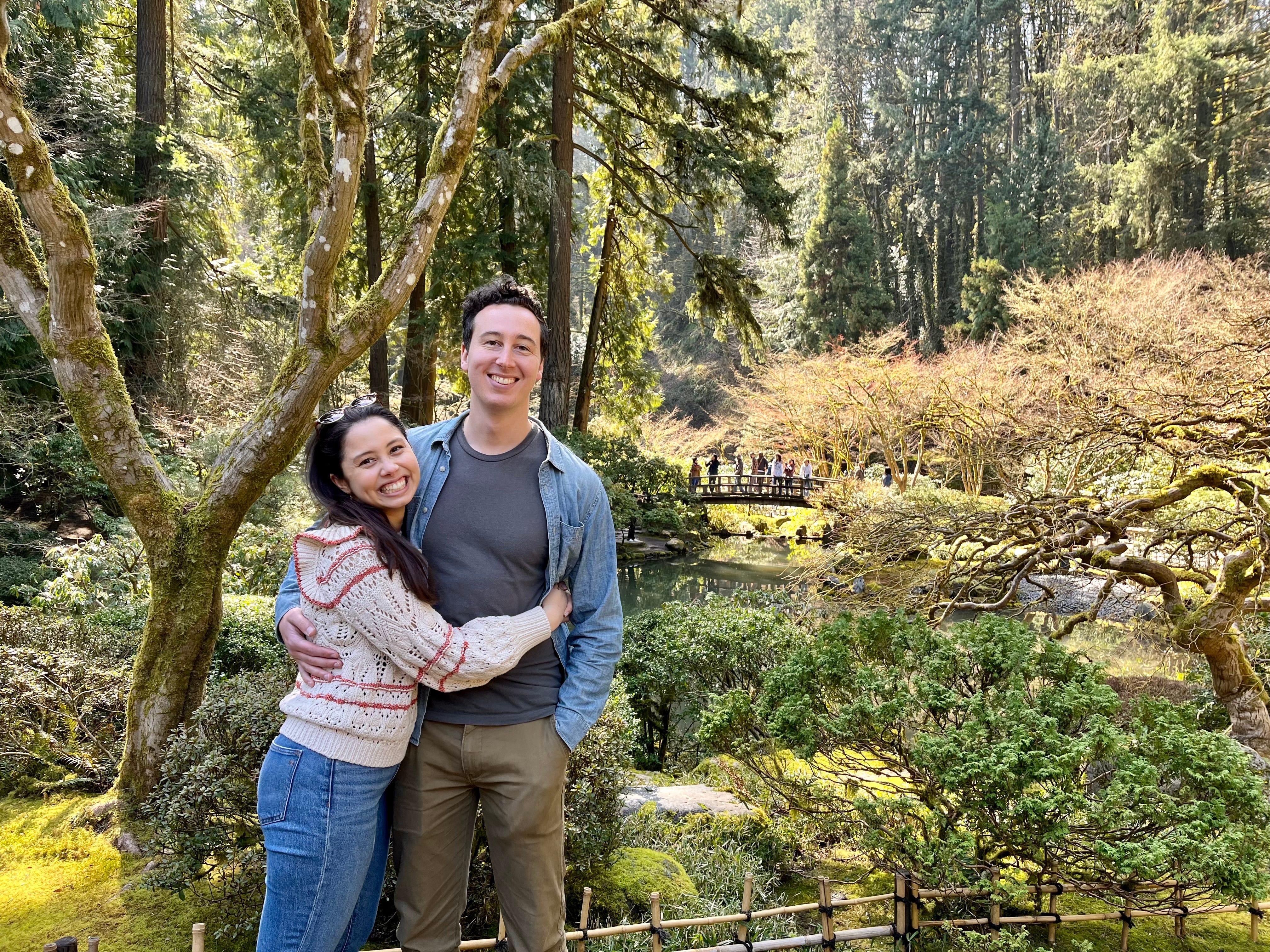 The author and his fiancee embrace while standing in a garden.