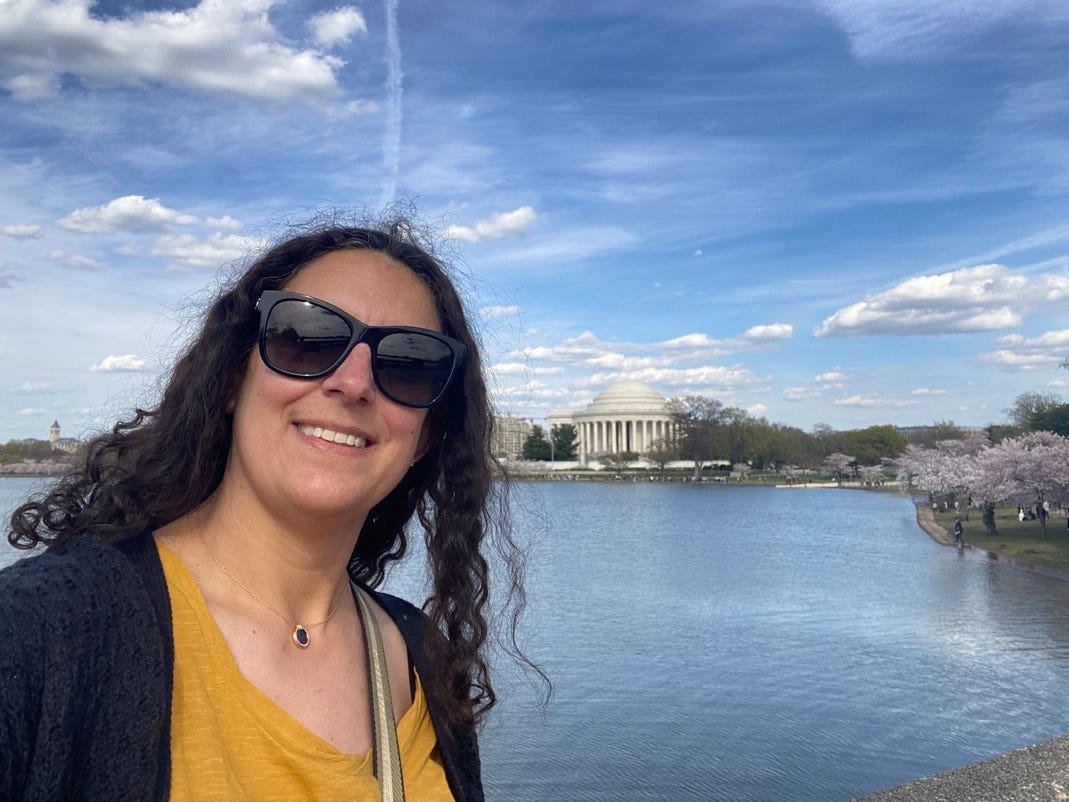 Author Jamie Davis Smith smiling near building in DC