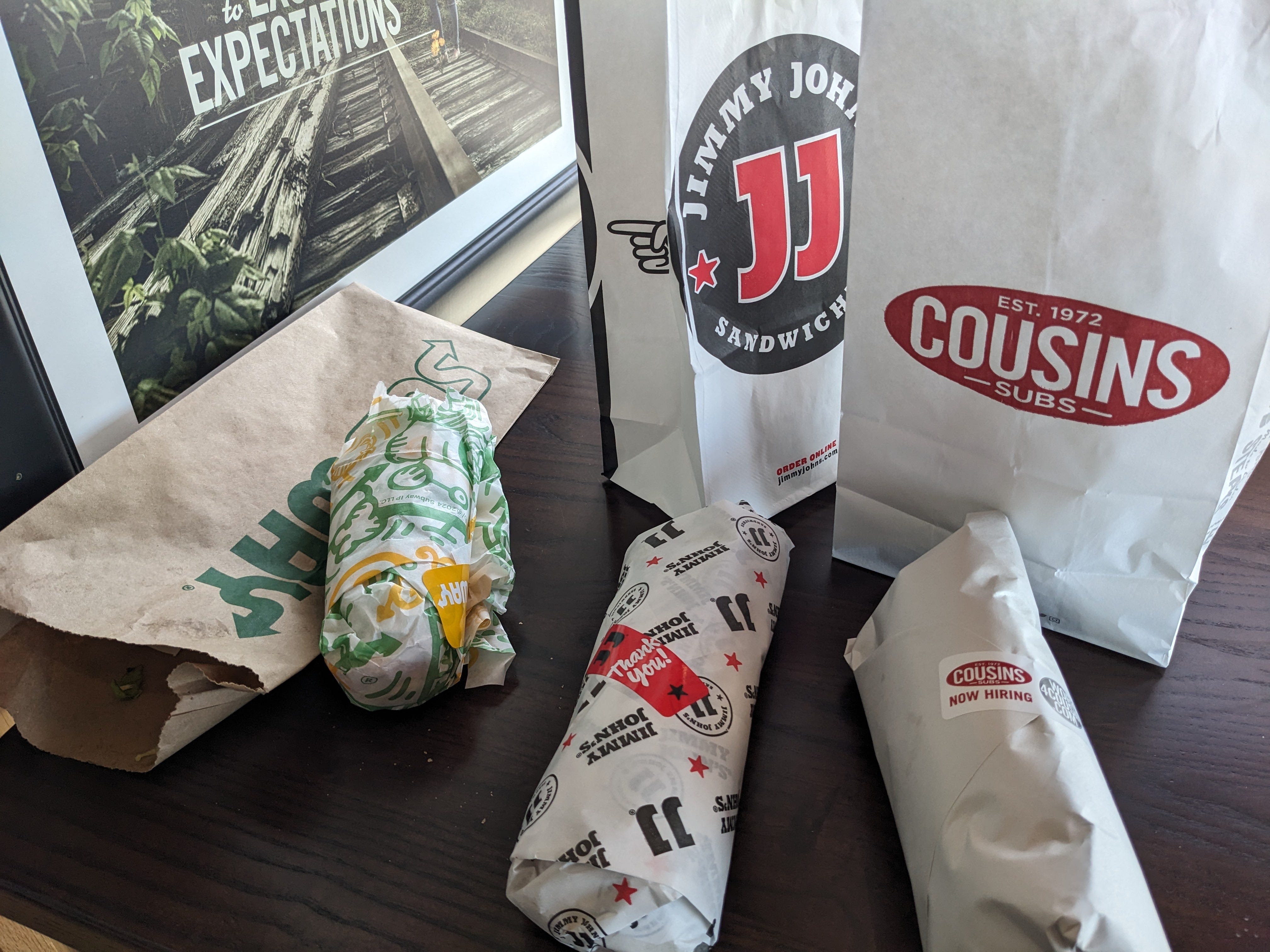 A spread of wrapped sandwiches from Subway, Jimmy John's, and Cousins Subs.