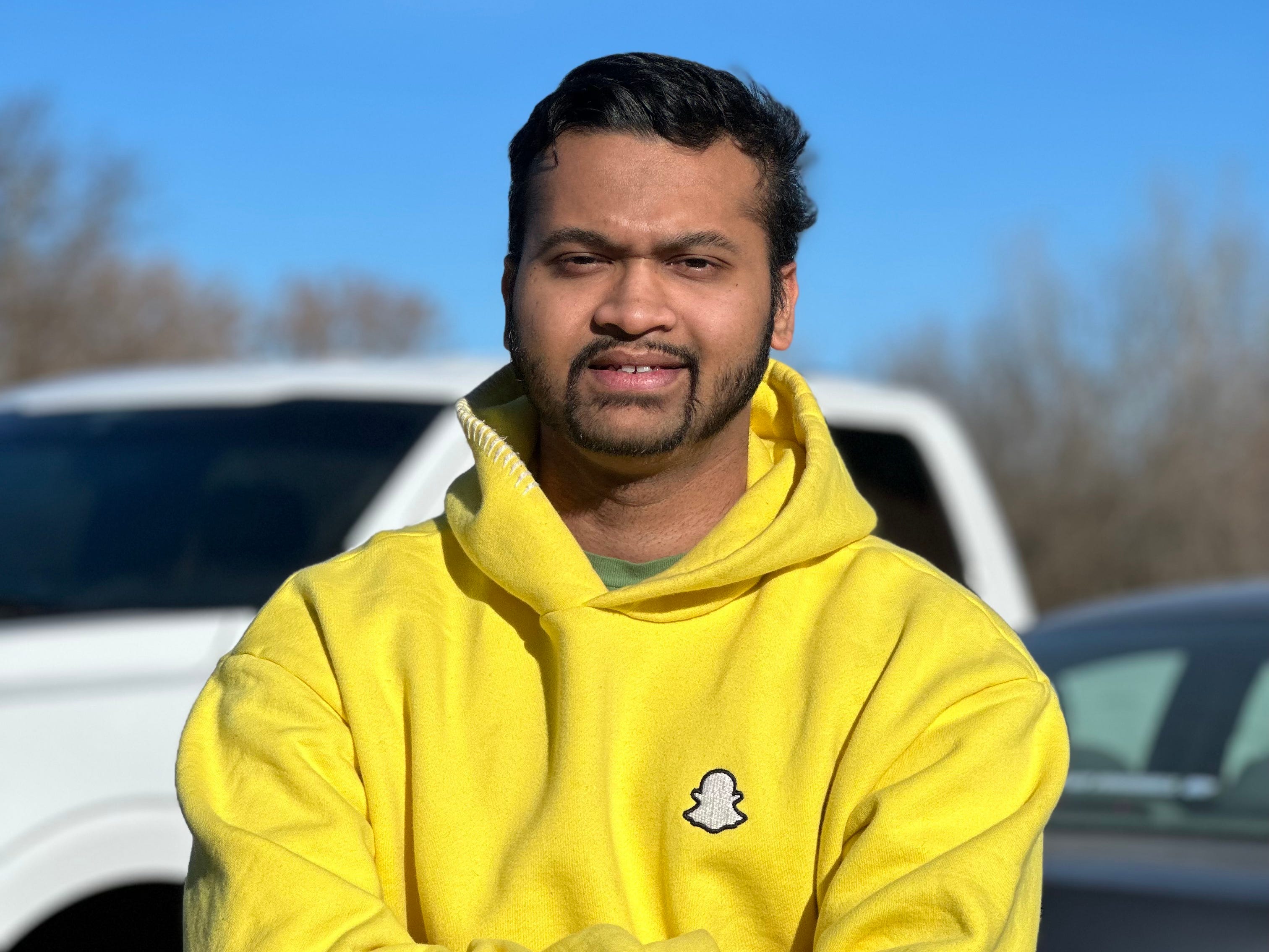 Mostofa Shakib wearing a yellow Snapchat hoodie