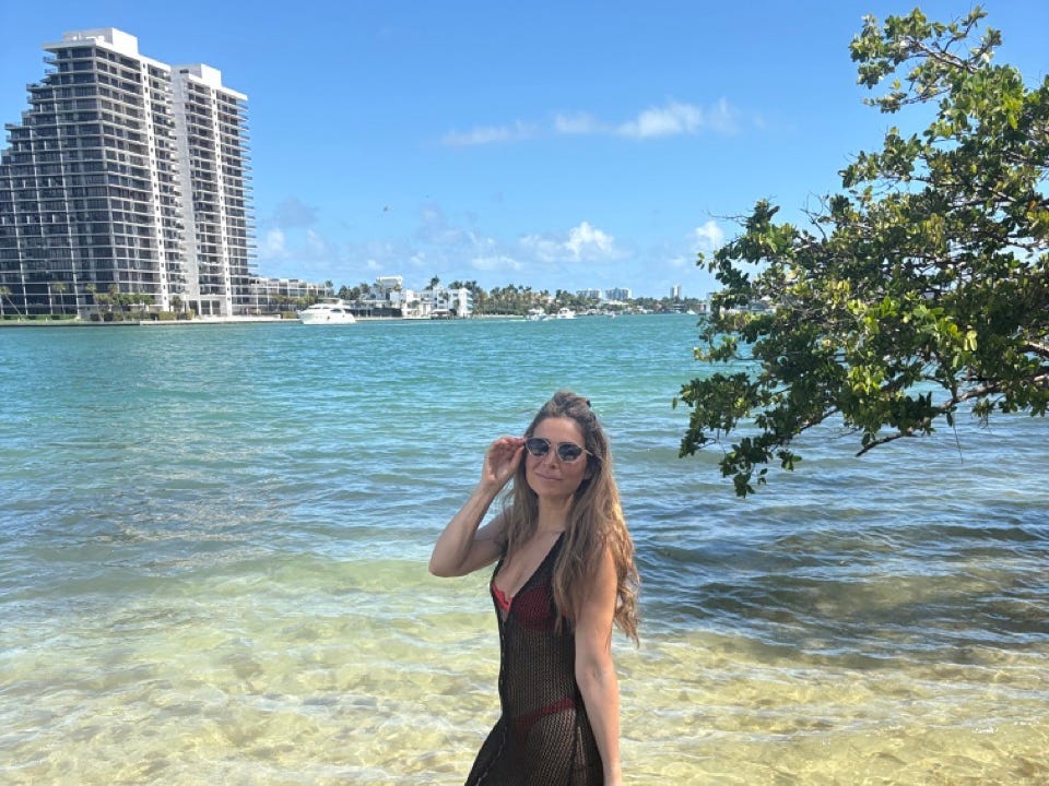 Author Leila Najafi smiling on beach in Miami