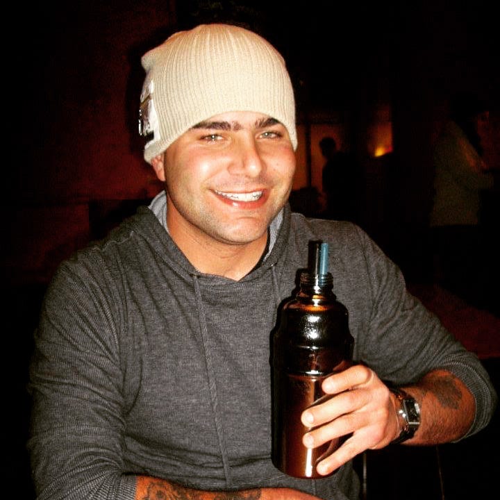 man with a water bottle in a gray long sleeve shirt