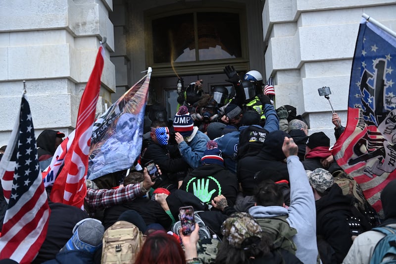 Trump supporters clash with police and security forces as they storm the US Capitol in Washington, DC on January 6, 2021.