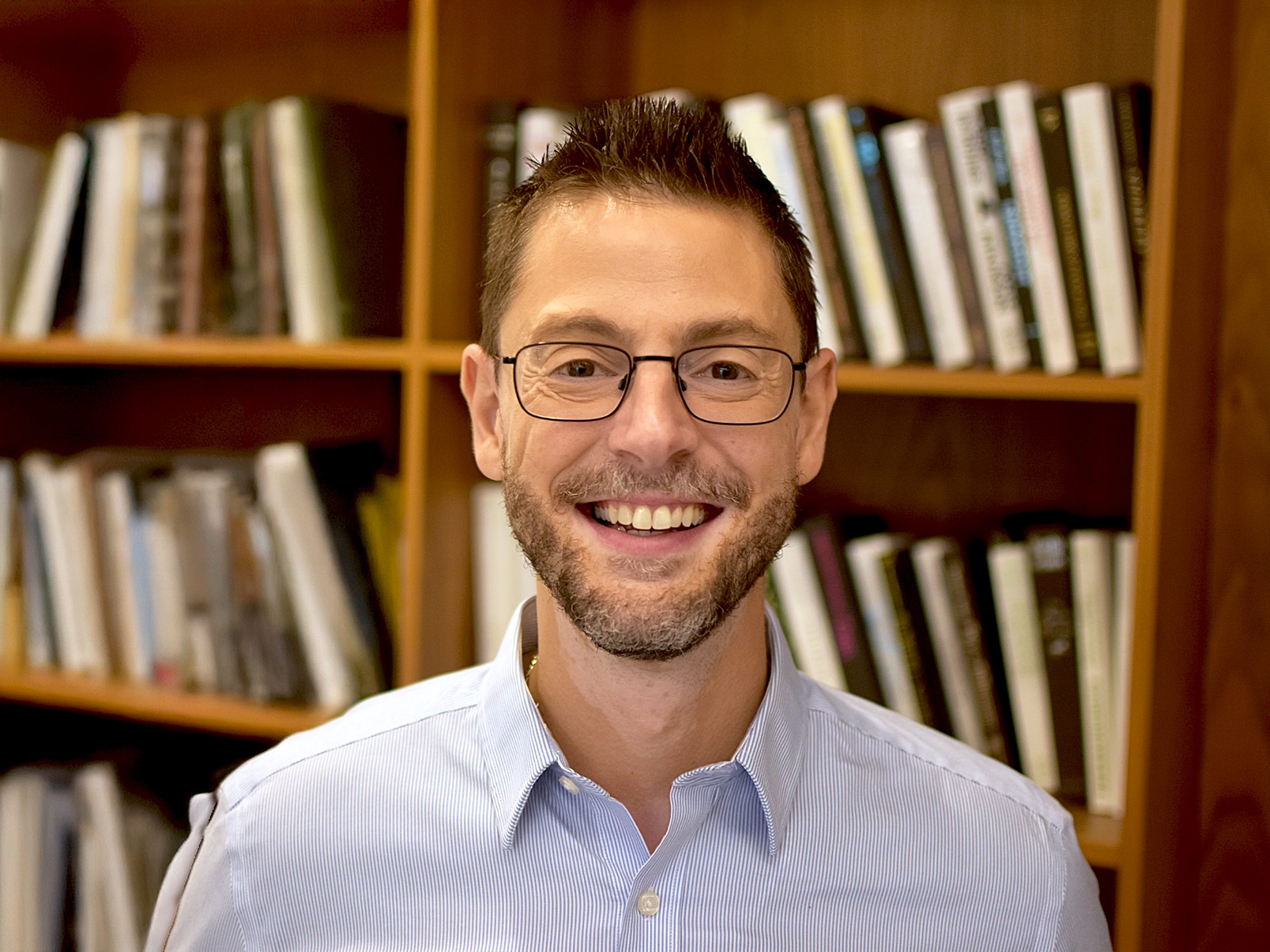 Noah Berk with books behind him