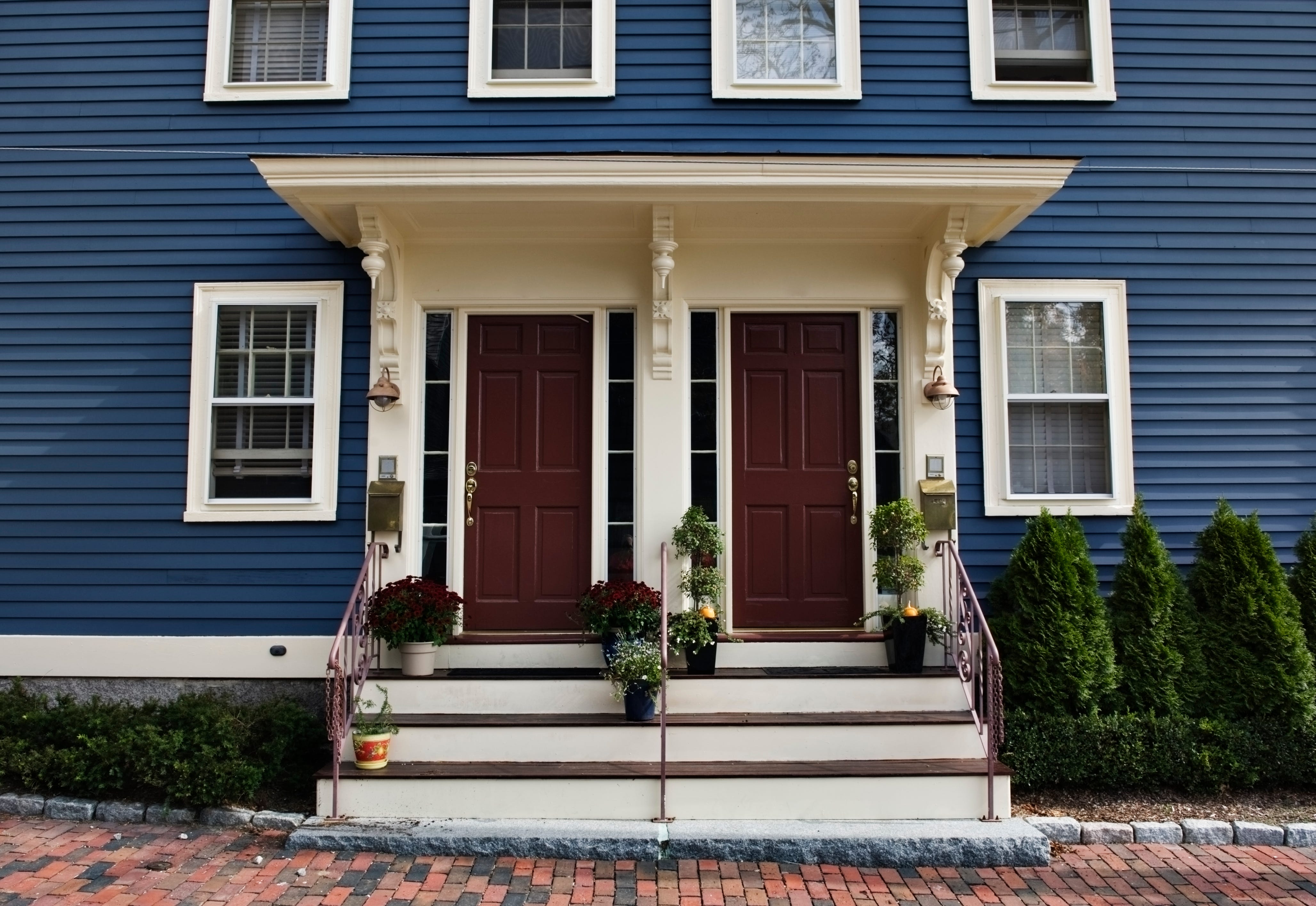 A blue duplex with a shared porch.