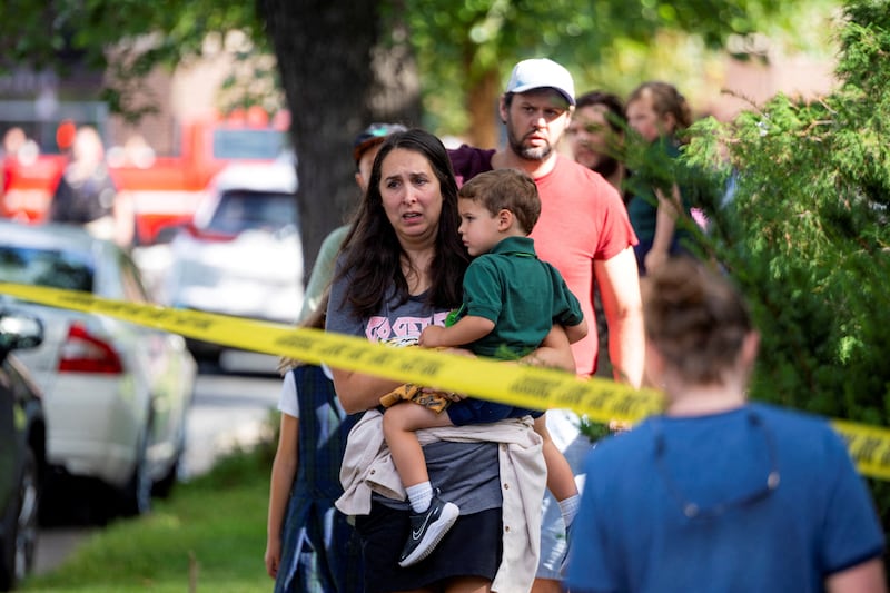 Families reunite outside the police barricades after a shooting at Annunciation Church, which is also home to an elementary school, in Minneapolis, Minnesota, Aug. 27, 2025.