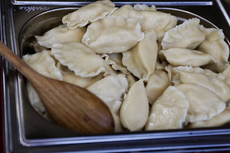 A tub of pierogi with a wooden spoon at the Easter market in Krakow, Poland on March 30, 2024.