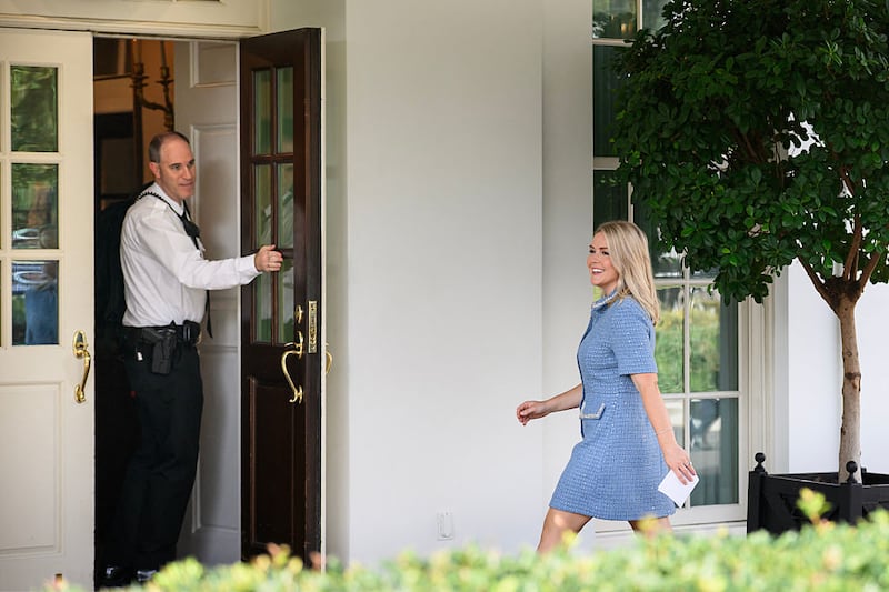 Karoline Leavitt walks into the West Wing after television interviews at the White House in Washington, DC on August 14, 2025.