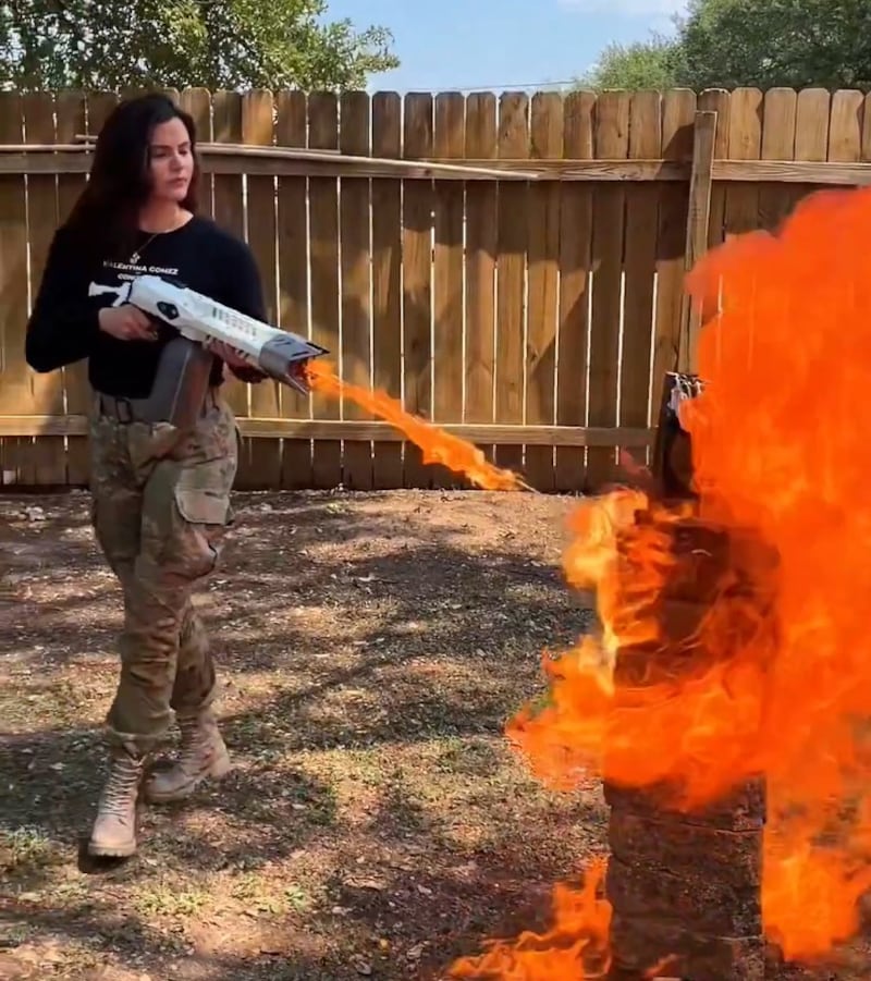 Valentina Gomez using a flamethrower to torch a Quran.