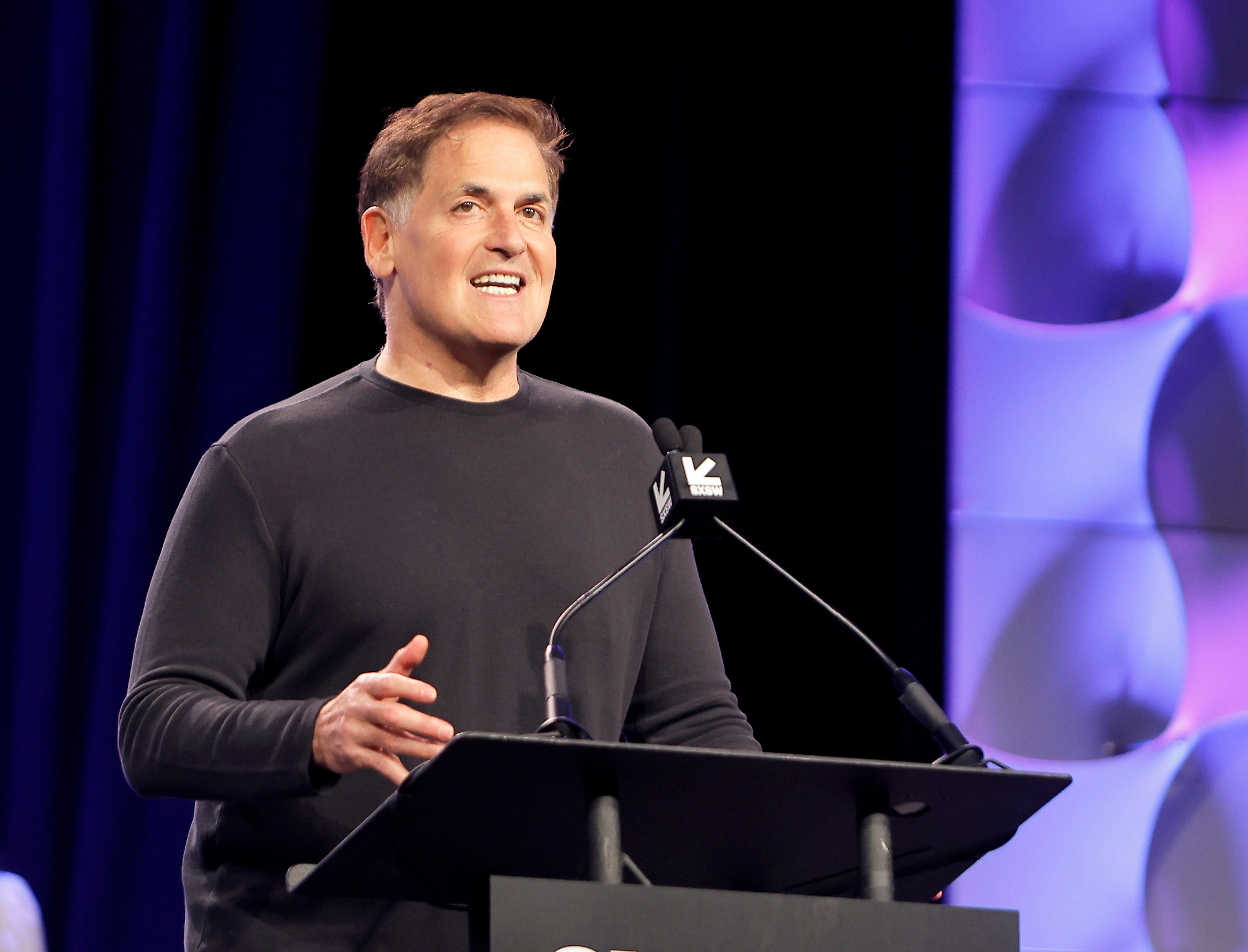 Mark Cuban speaking onstage at a conference at the Austin Convention Center.