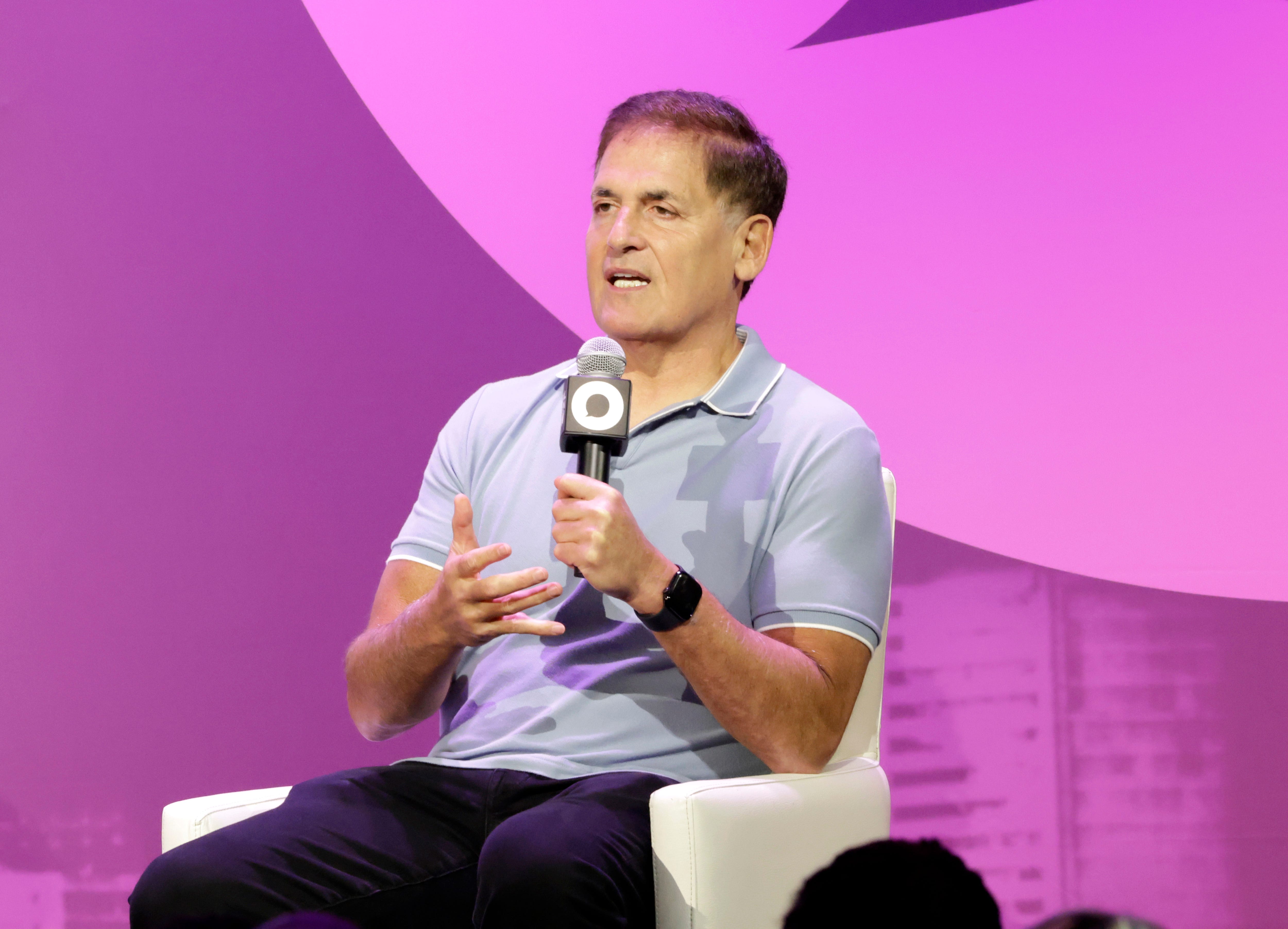 Mark Cuban is holding a microphone and speaking.