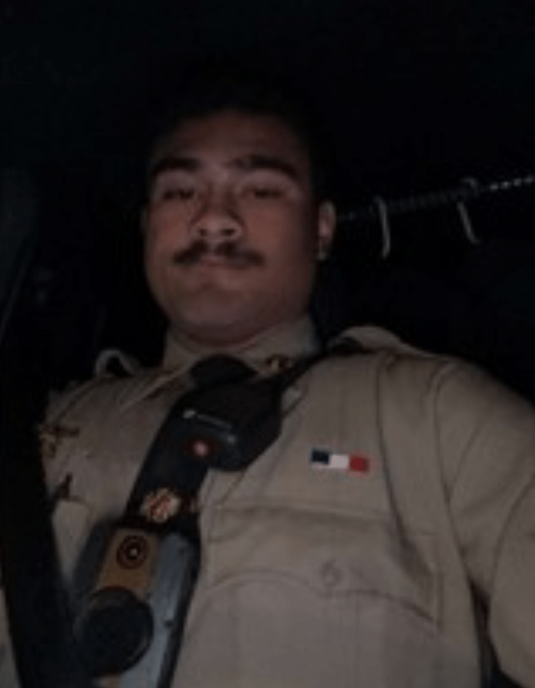 Ballard posed in photos wearing a beige uniform with a radio attached to his chest. 