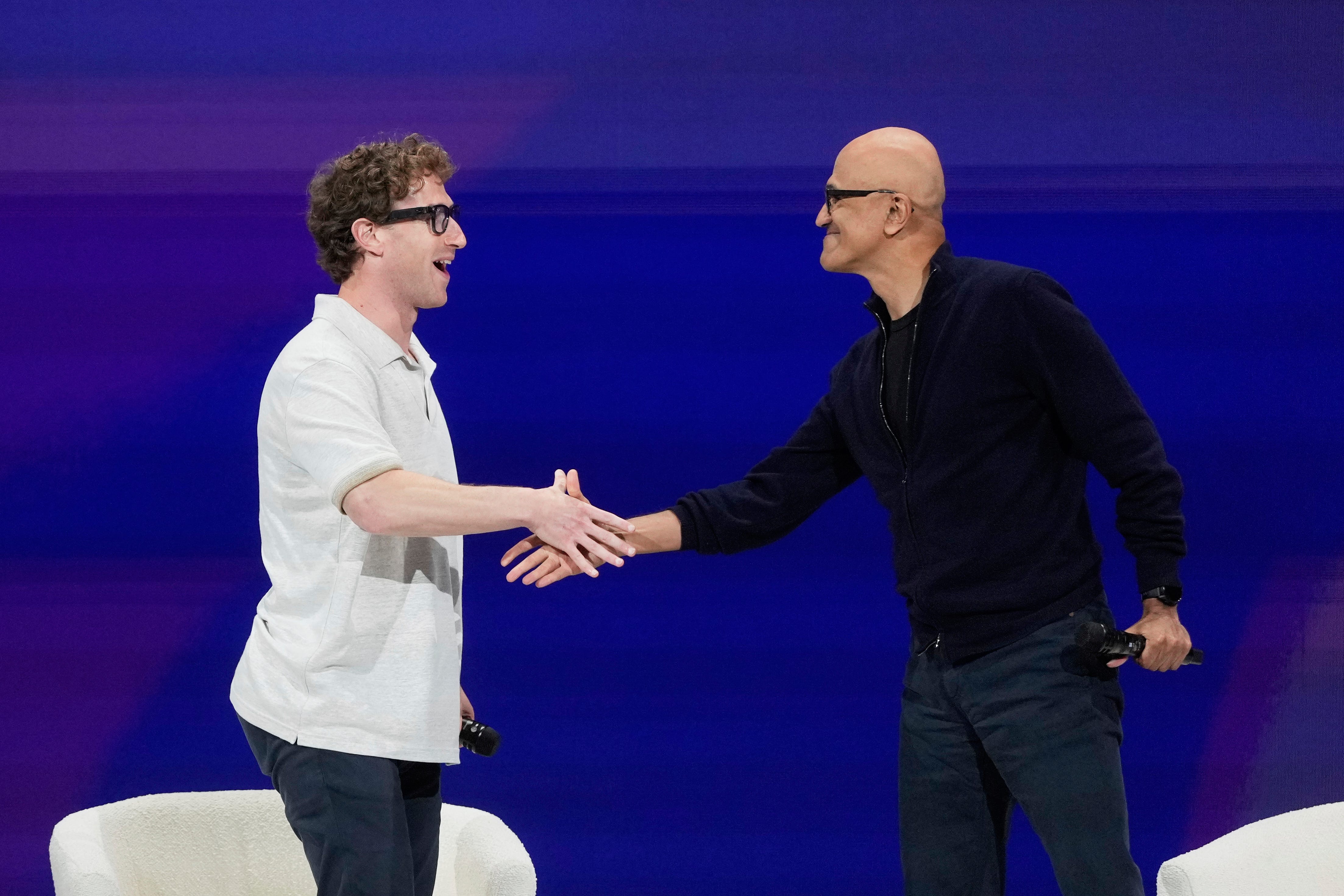 Meta CEO Mark Zuckerberg and Microsoft CEO Satya Nadella shake hands at LlamaCon.