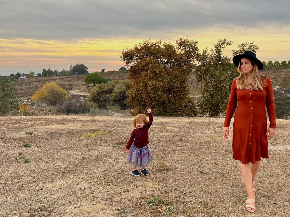 The author and her young daughter pose outside.