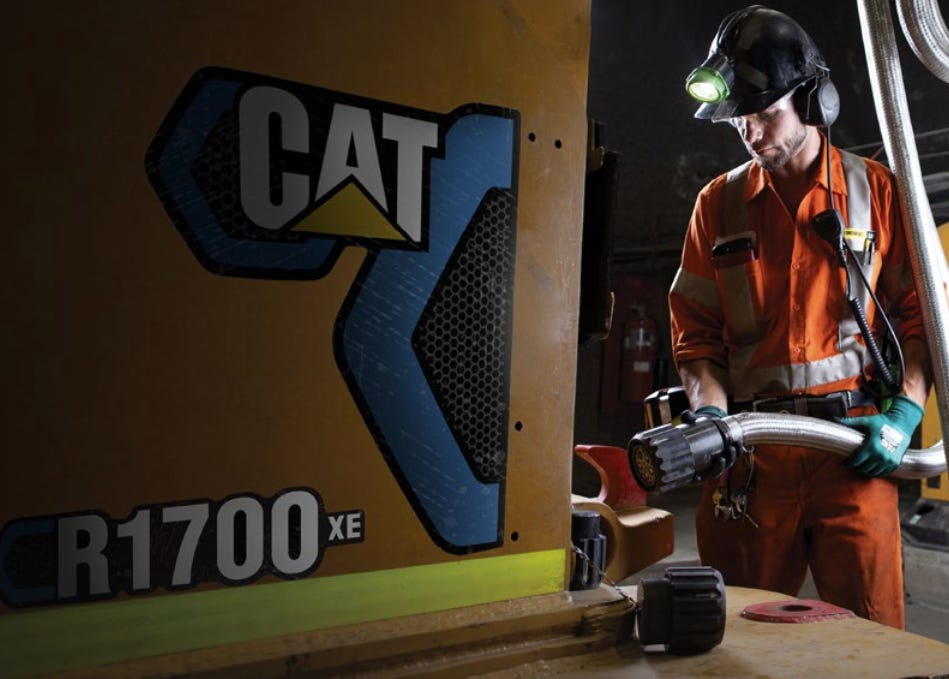 A miner plugs in a Caterpillar's R1700 XE battery-powered underground loader