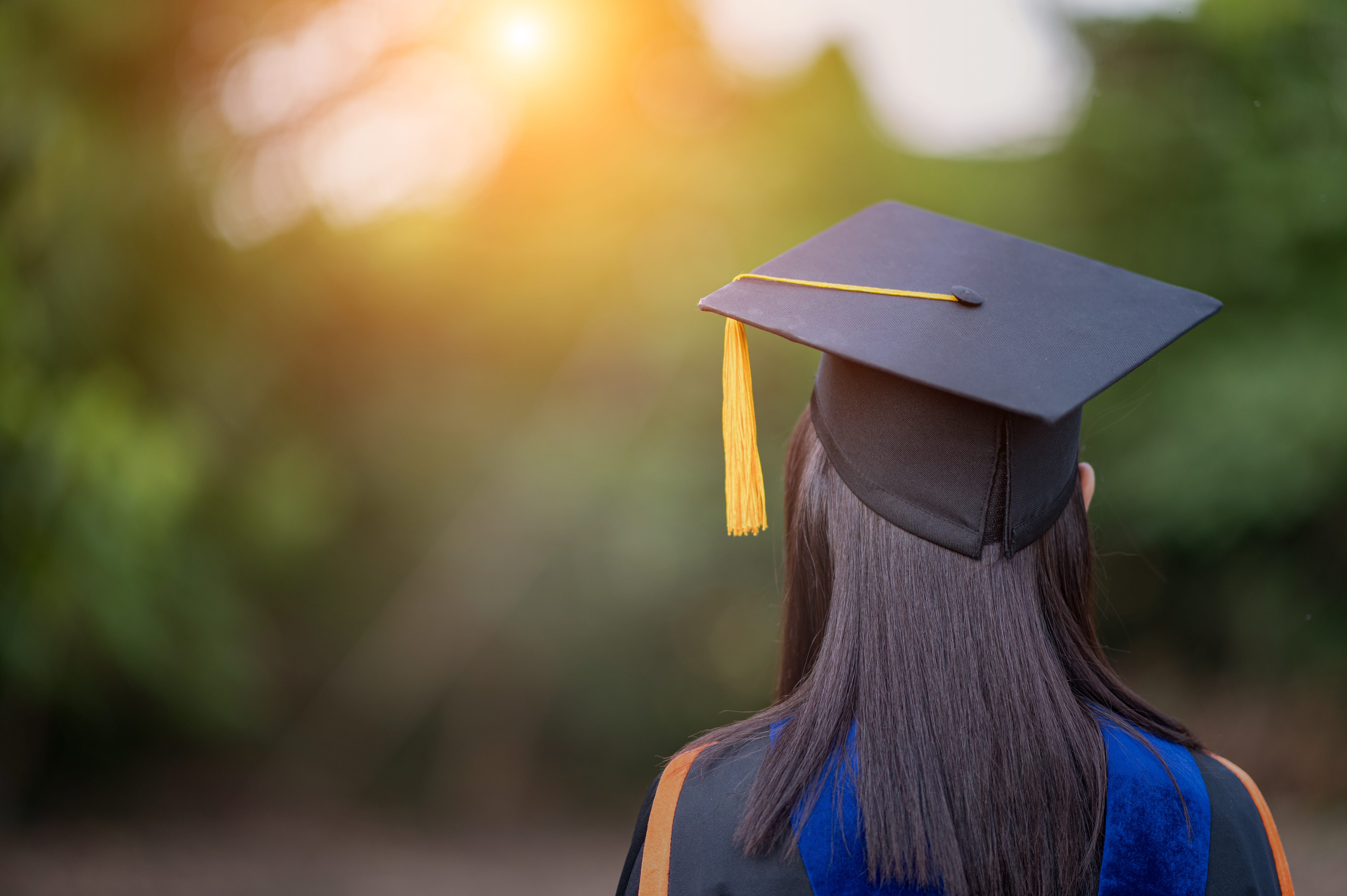 Rear view of college graduate