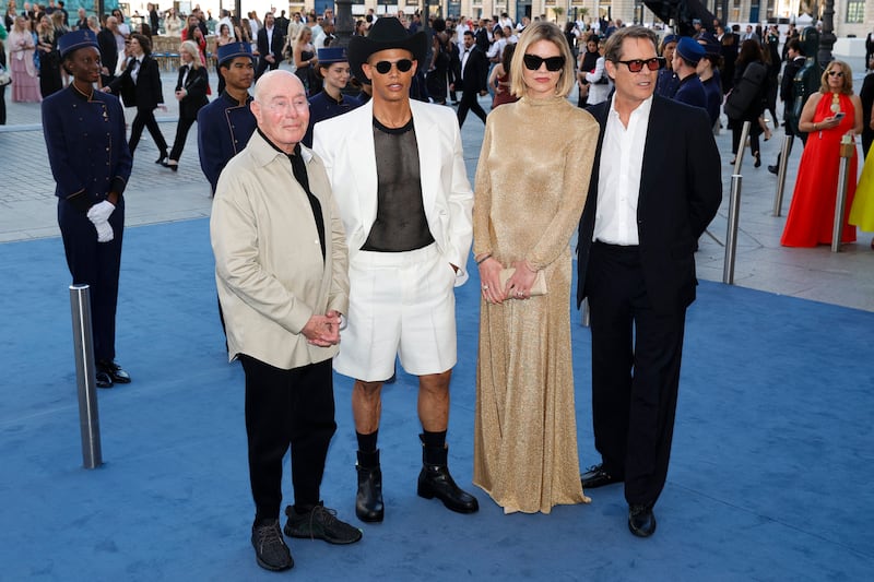 (From L) US producer David Geffen, Donovan Michaels, British model Lady Jemma Mornington and French businessman Arpad Busson poses during a photocall upon arrival to attend the Spring/Summer 2025 menswear ready to wear joint fashion show hosted by Vogue World as part of Paris Fashion Week at Place Vendome in Paris, on June 23, 2024, ahead of the upcoming Paris 2024 Olympic Games. (Photo by Geoffroy VAN DER HASSELT / AFP) (Photo by GEOFFROY VAN DER HASSELT/AFP via Getty Images)