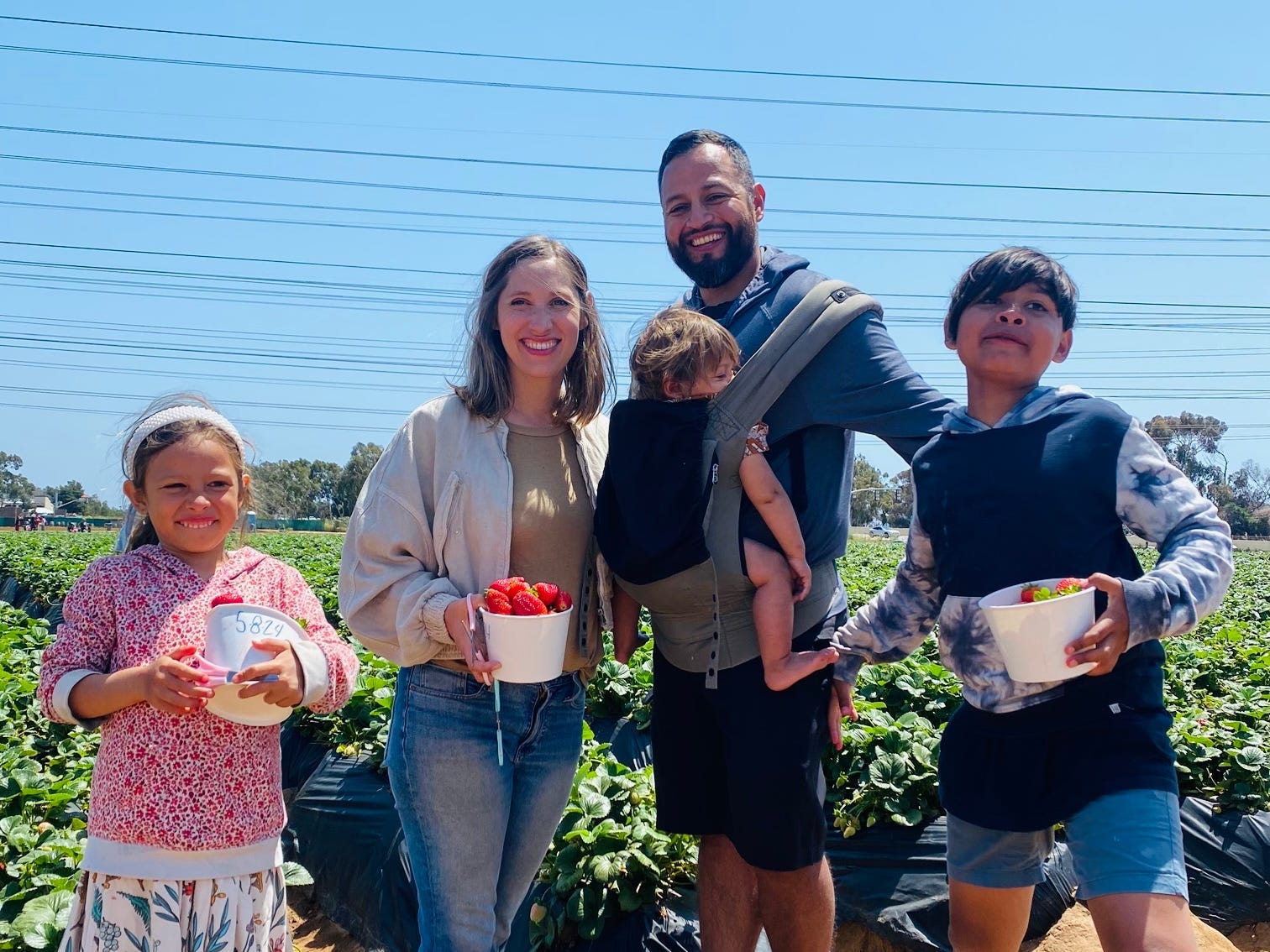 The author with her family picking fruit at a farm.