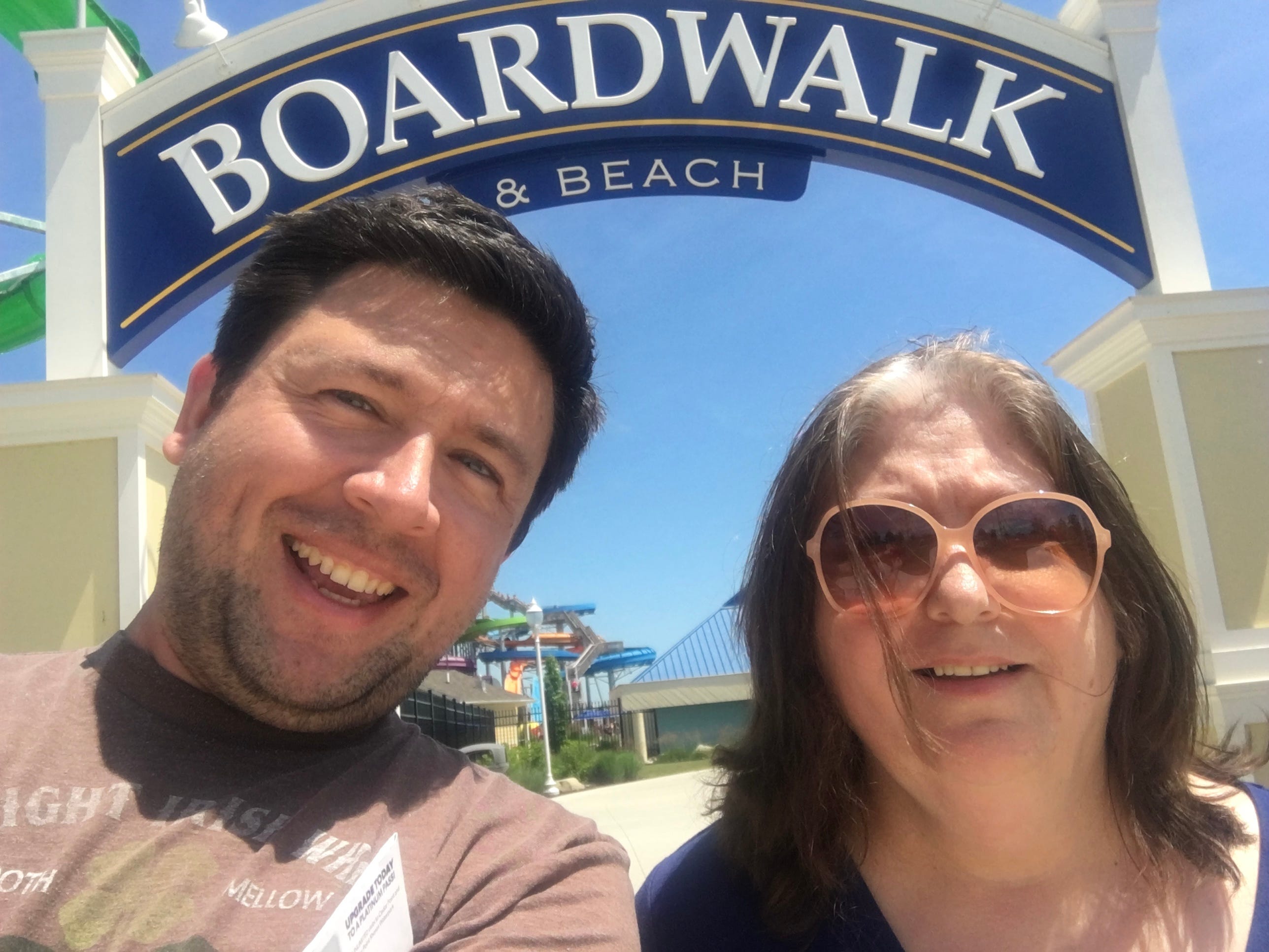 The author and his mother posse on a beach boardwalk.
