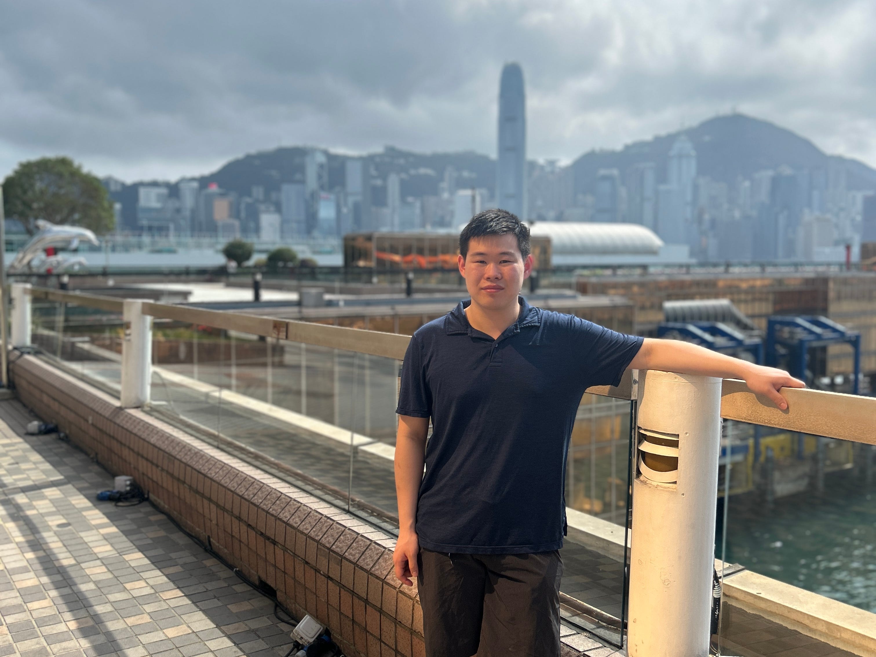 Kennedy Liu is standing on Hong Kong Pier.
