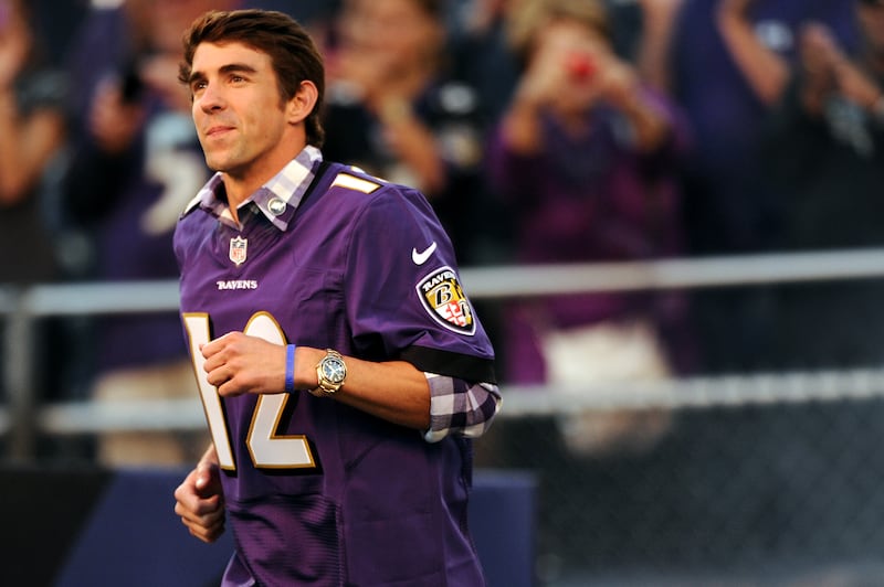 Michael Phelps led the Baltimore Ravens’ offense onto the field in 2012, shortly after returning from the London Olympics.