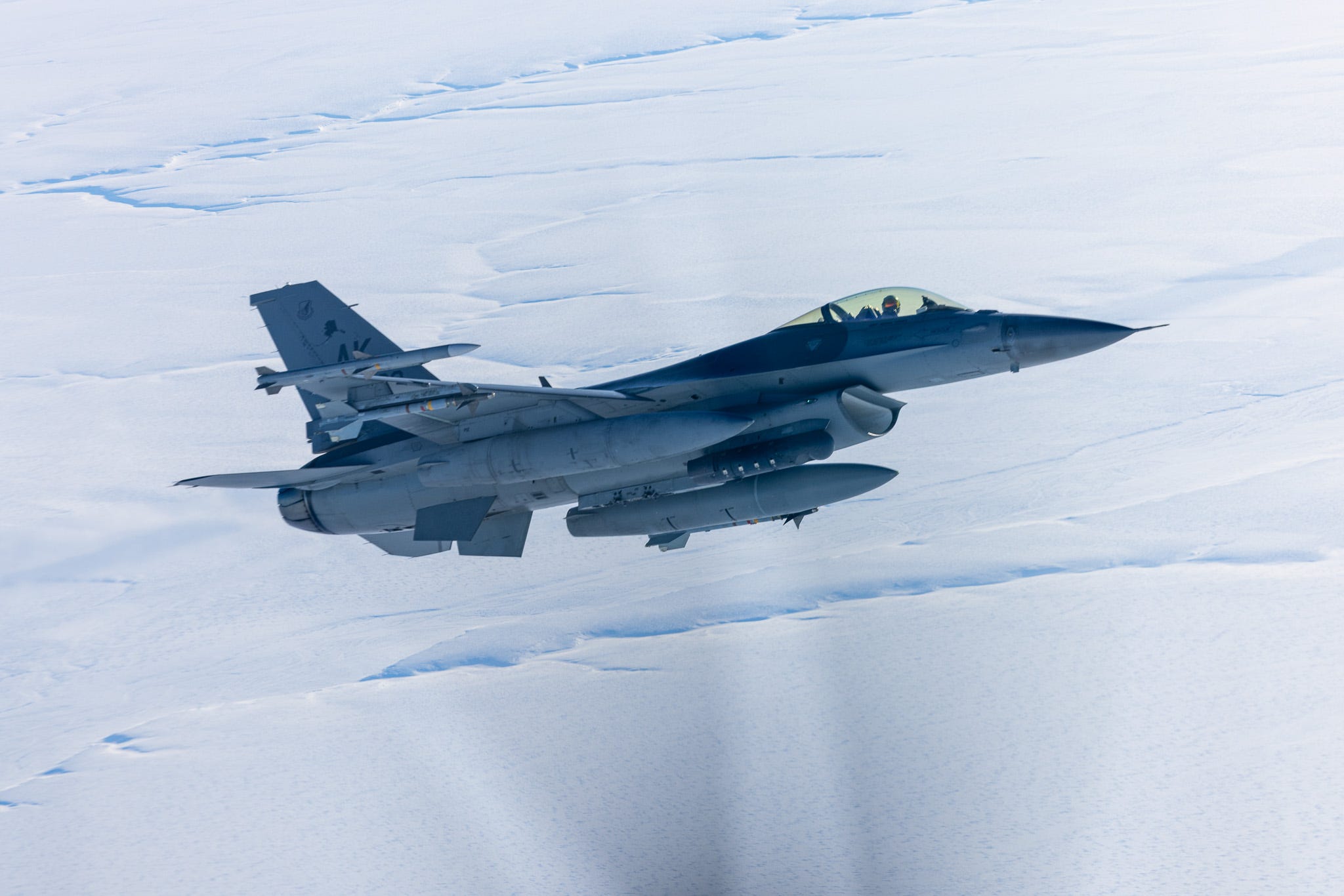North American Aerospace Defense Command CF-18 Hornets and F-16 Fighting Falcons escort a LC-130 Hercules assigned to the 109th Airlift Wing over the North Slope of Alaska, February 26, 2025.