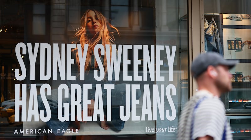 A window display of actress Sydney Sweeney is seen on a window of an American Eagle store on August 01, 2025 in New York City. American Eagle’s recent denim ad campaign featuring Sweeney has drawn backlash for language and imagery that critics say echoes eugenics-era rhetoric, following a tagline referencing “great genes” alongside visuals of Sweeney in blue jeans.