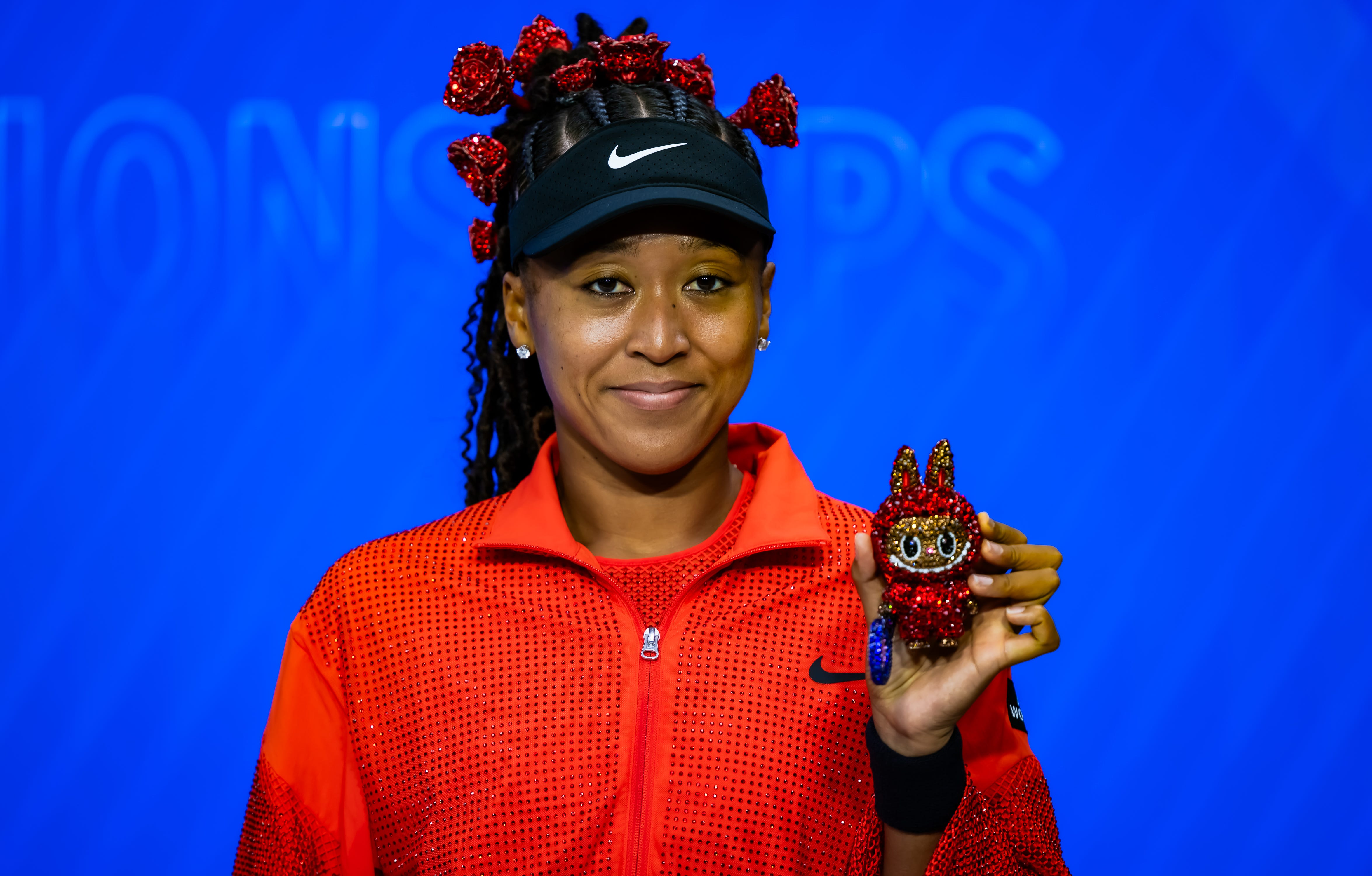 Naomi Osaka of Japan poses for a photo with her Labubu after defeating Greet Minnen of Belgium in the first round on Day 3 of the US Open at USTA Billie Jean King National Tennis Center on August 26, 2025 in New York City.