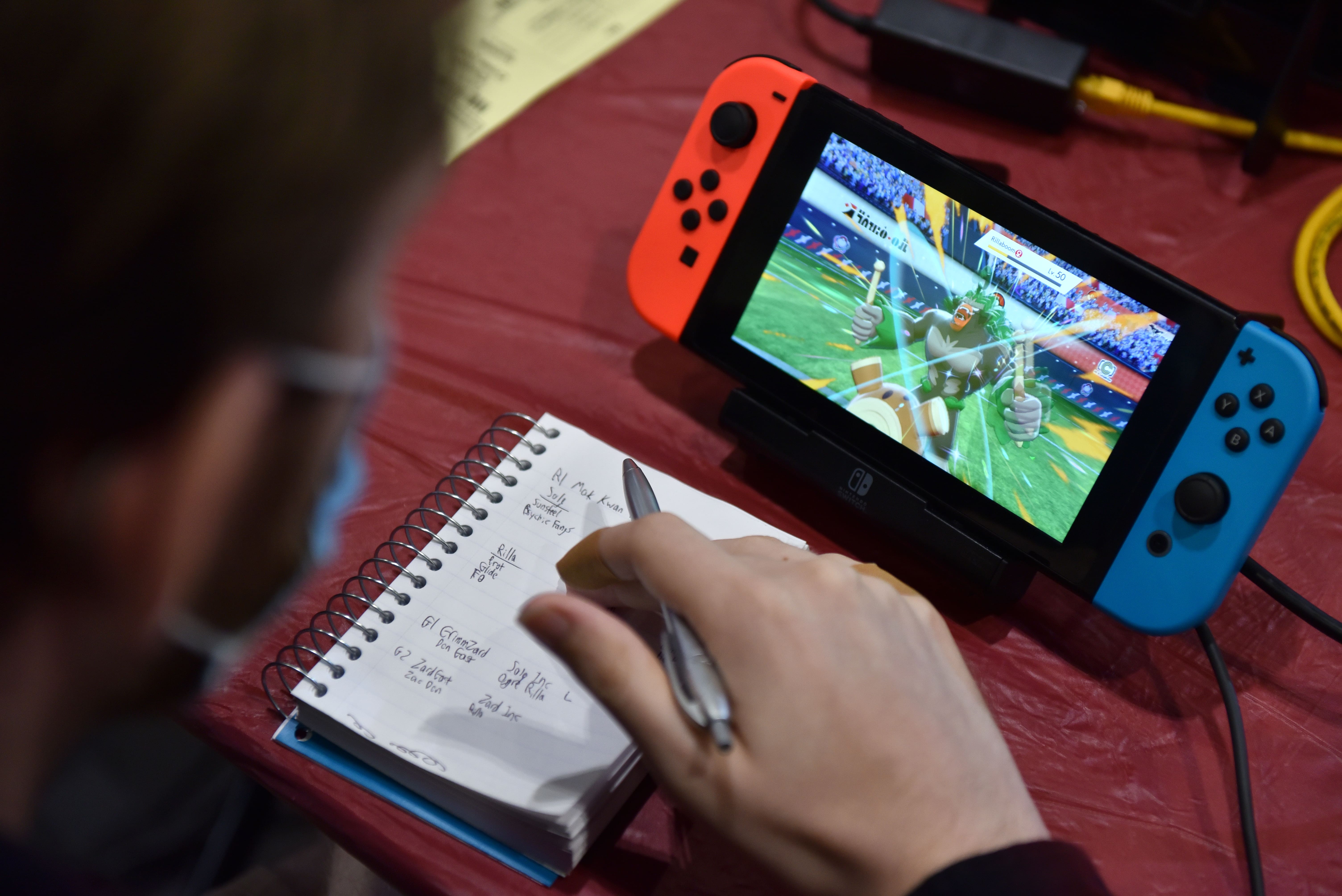 A competitor makes notes while playing Pokemon on a Nintendo Switch console during the 2022 Pokémon World Championships at ExCel on August 18, 2022 in London, England.