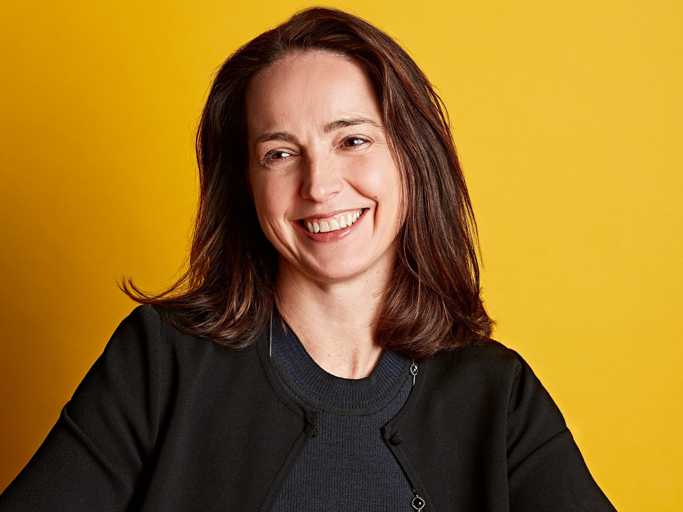 Sarah Friar sitting at a table