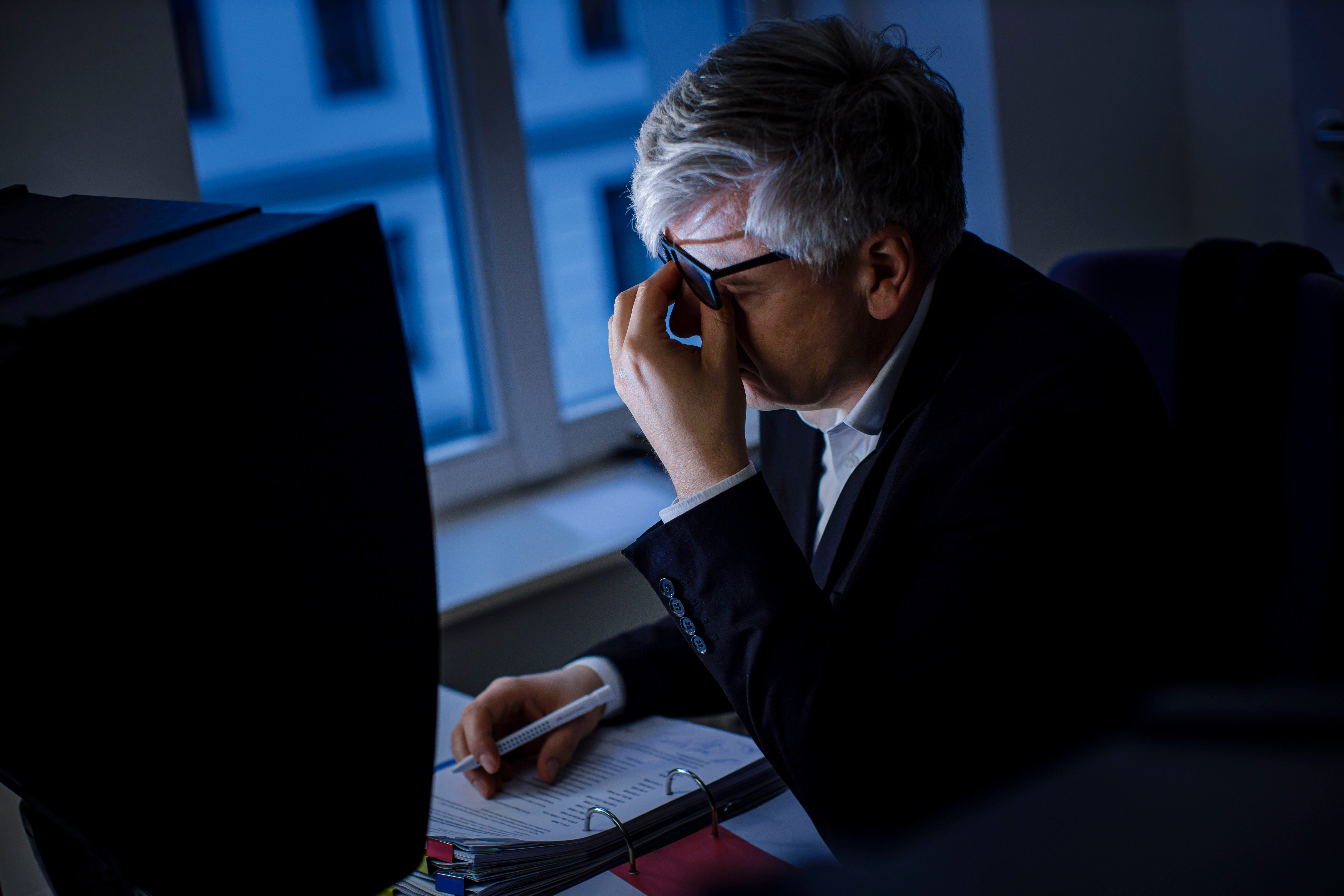 A stressed worker is pictured.