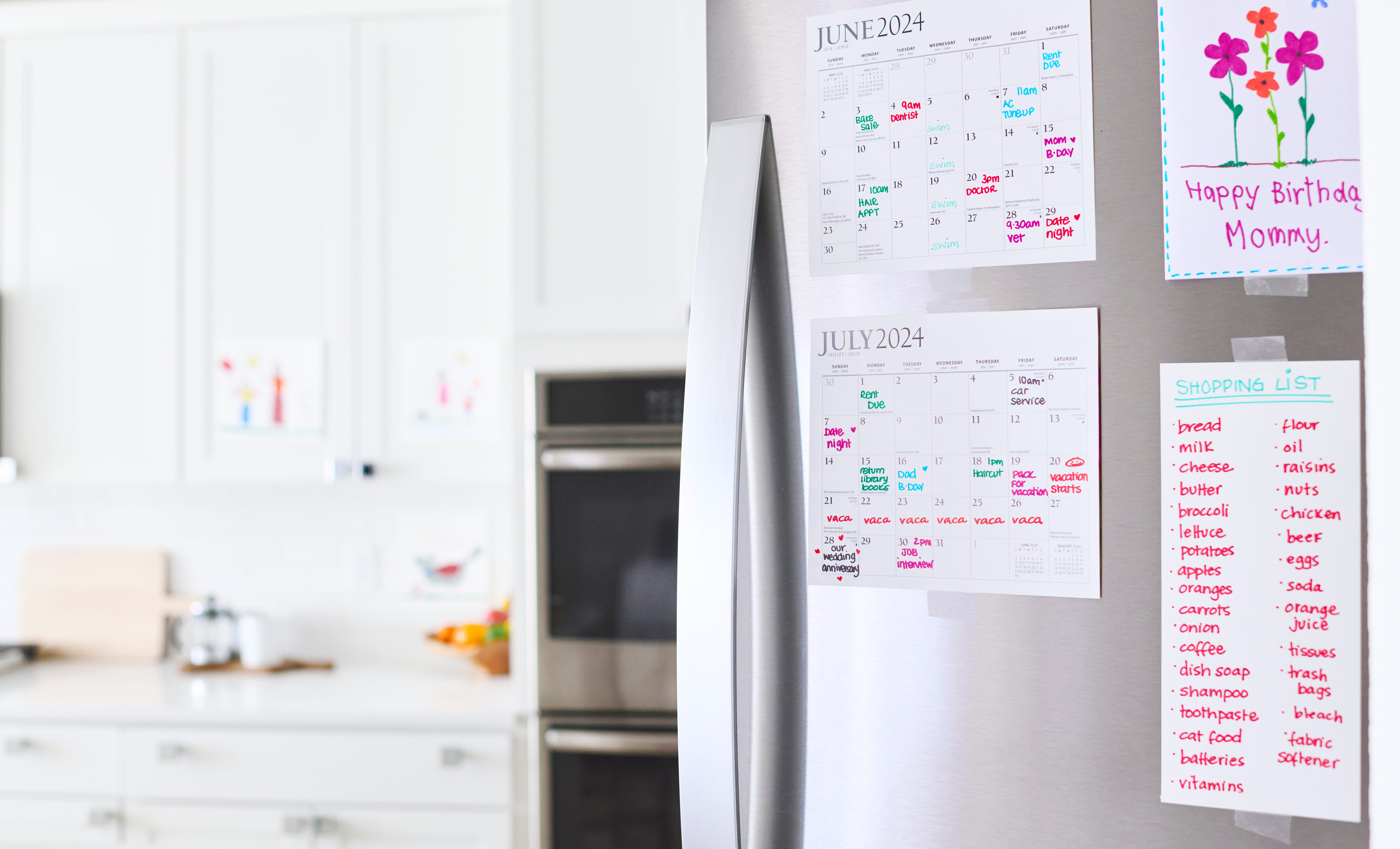 A stainless fridge in a kitchen is covered with family planning items including a shopping list and calendars.