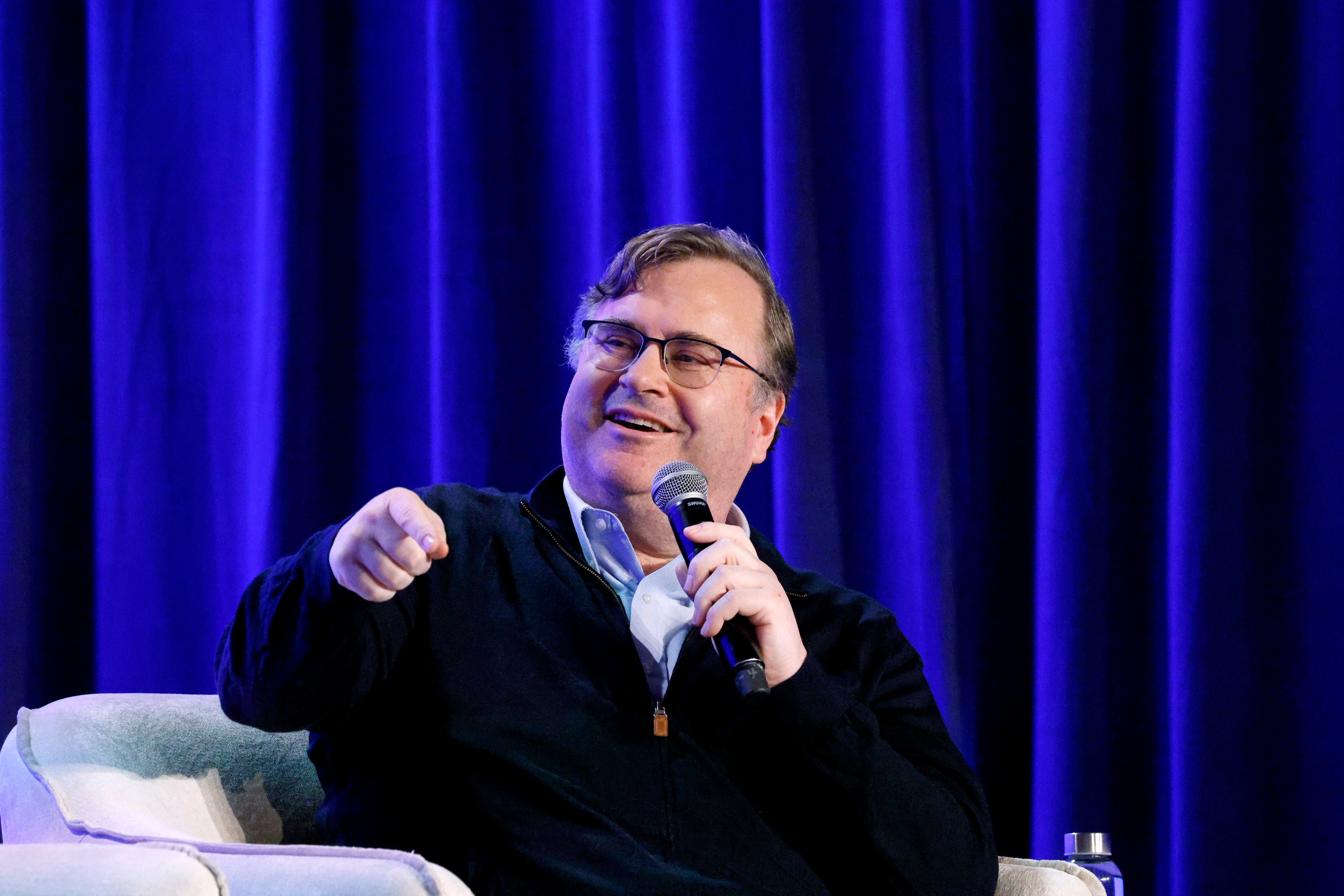Reid Hoffman speaking onstage at a conference in San Francisco, California.