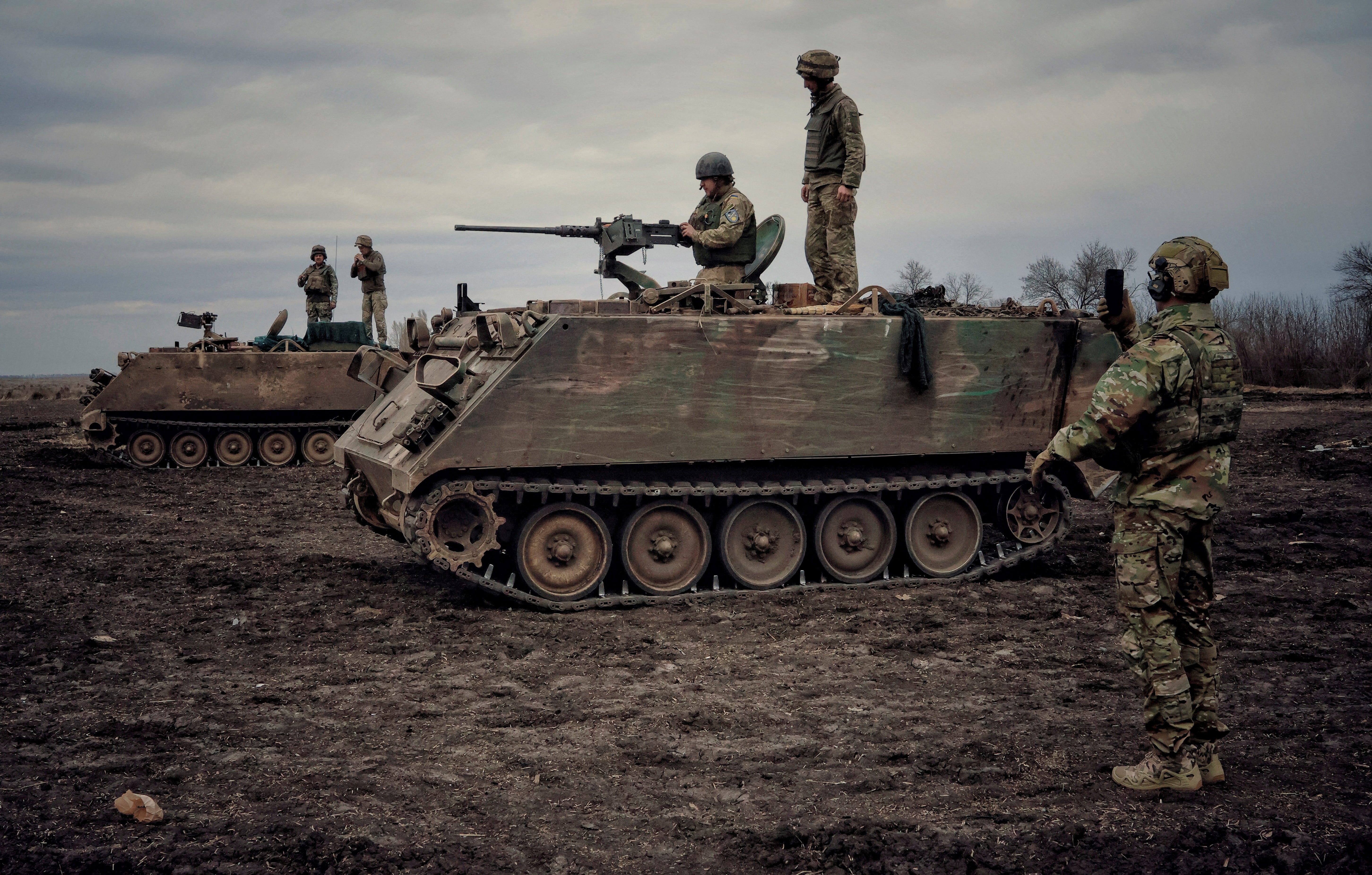 Ukrainian servicemen train to shoot a machine gun from M113 Armoured Personnel Carrier (APC) during a training session, amid Russia's invasion of Ukraine, in Donbas region, Ukraine April 8, 2023.