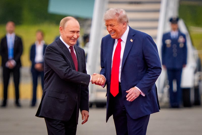 ANCHORAGE, ALASKA - AUGUST 15: (EDITOR'S NOTE: Alternate Crop) U.S. President Donald Trump (R) greets Russian President Vladimir Putin as he arrives at Joint Base Elmendorf-Richardson on August 15, 2025 in Anchorage, Alaska. The two leaders are meeting for peace talks aimed at ending the war in Ukraine. (Photo by Andrew Harnik/Getty Images)