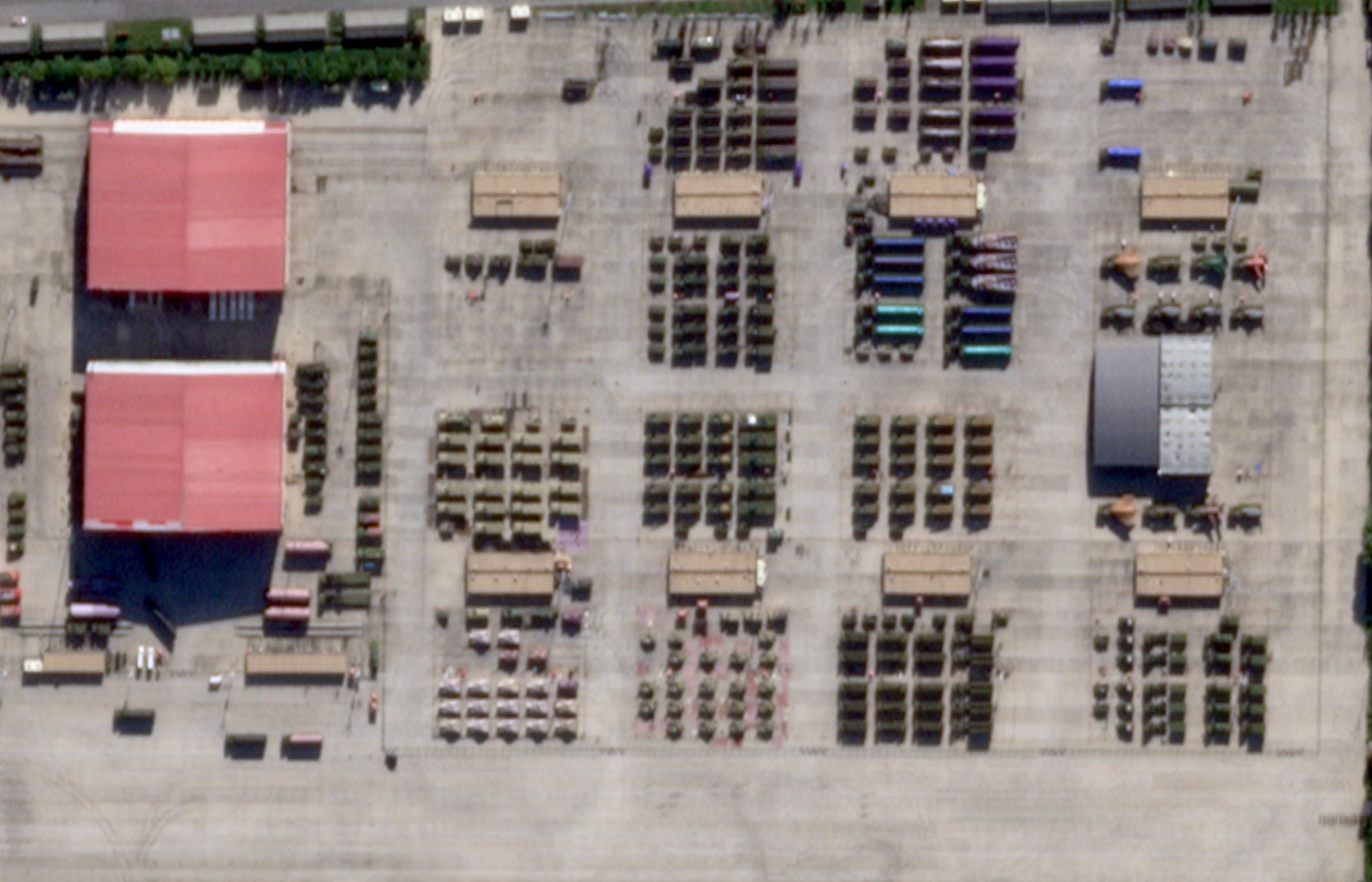 Satellite images show dozens of mobile systems parked in rows and columns.