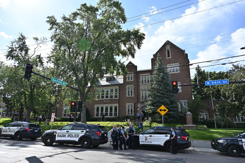 Police and first responders work at the scene of a shooting near Annunciation Church and Catholic School in Minneapolis, Minneosta, on Aug. 27, 2025. Two children were shot dead when a gunman attacked a Minneapolis church on Wednesday, with 17 people injured, 14 of them children, police said. The gunman