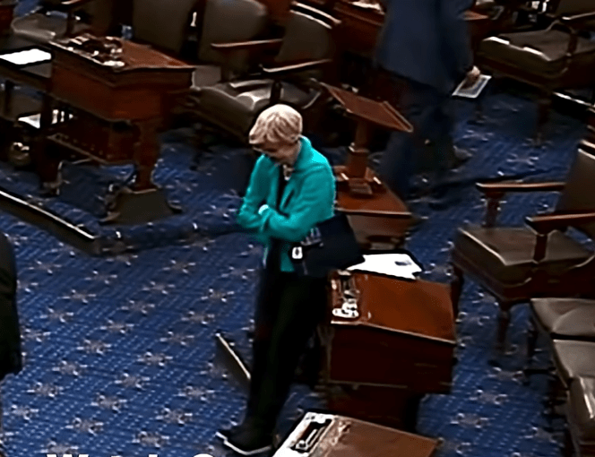 Sen. Elizabeth Warren goes to lean on a desk on the Senate floor during a vote on July 31, 2025.