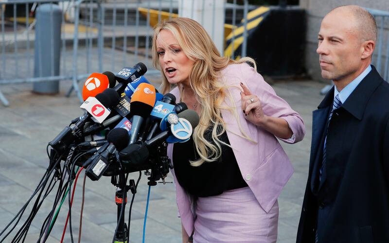 Adult film actress Stephanie Clifford, also known as Stormy Daniels, speaks to media along with her lawyer Michael Avenatti (right) outside federal court in New York City on April 16, 2018.
