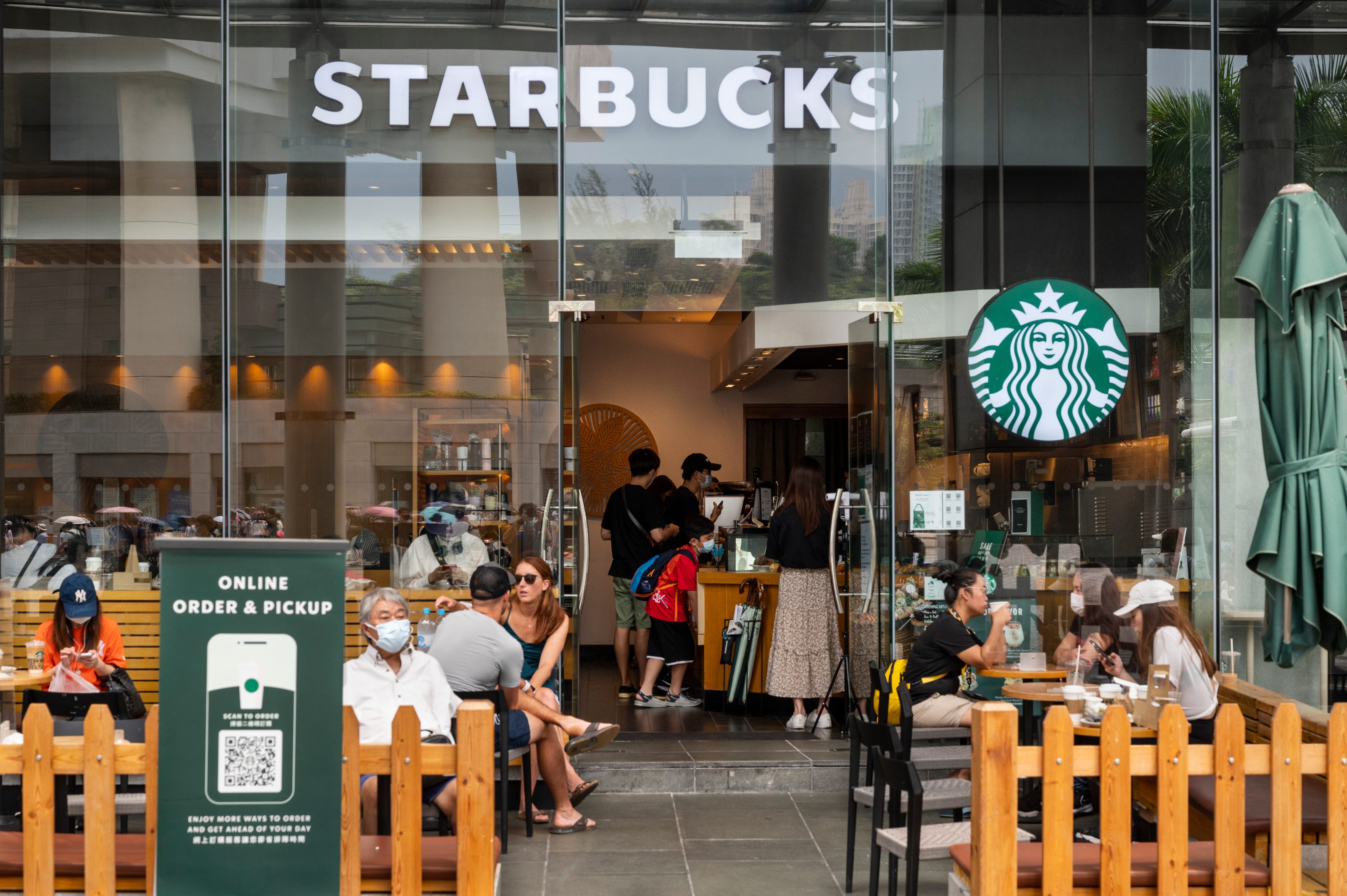 Customers are seen at the American multinational chain Starbucks Coffee store seen in Hong Kong's Tung Chung district.
