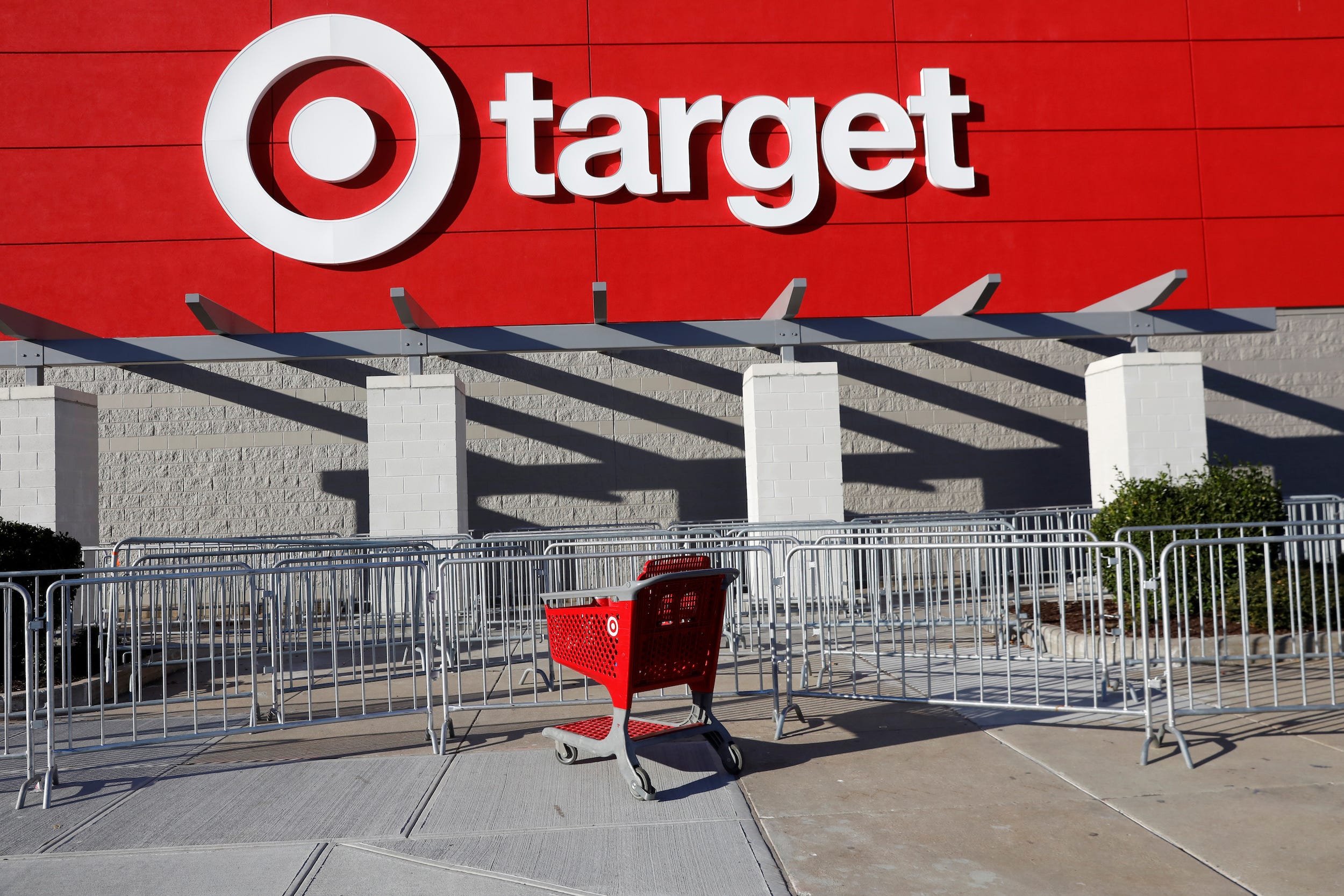 Empty shopping cart sits next to empty pens at Target store on Black Friday