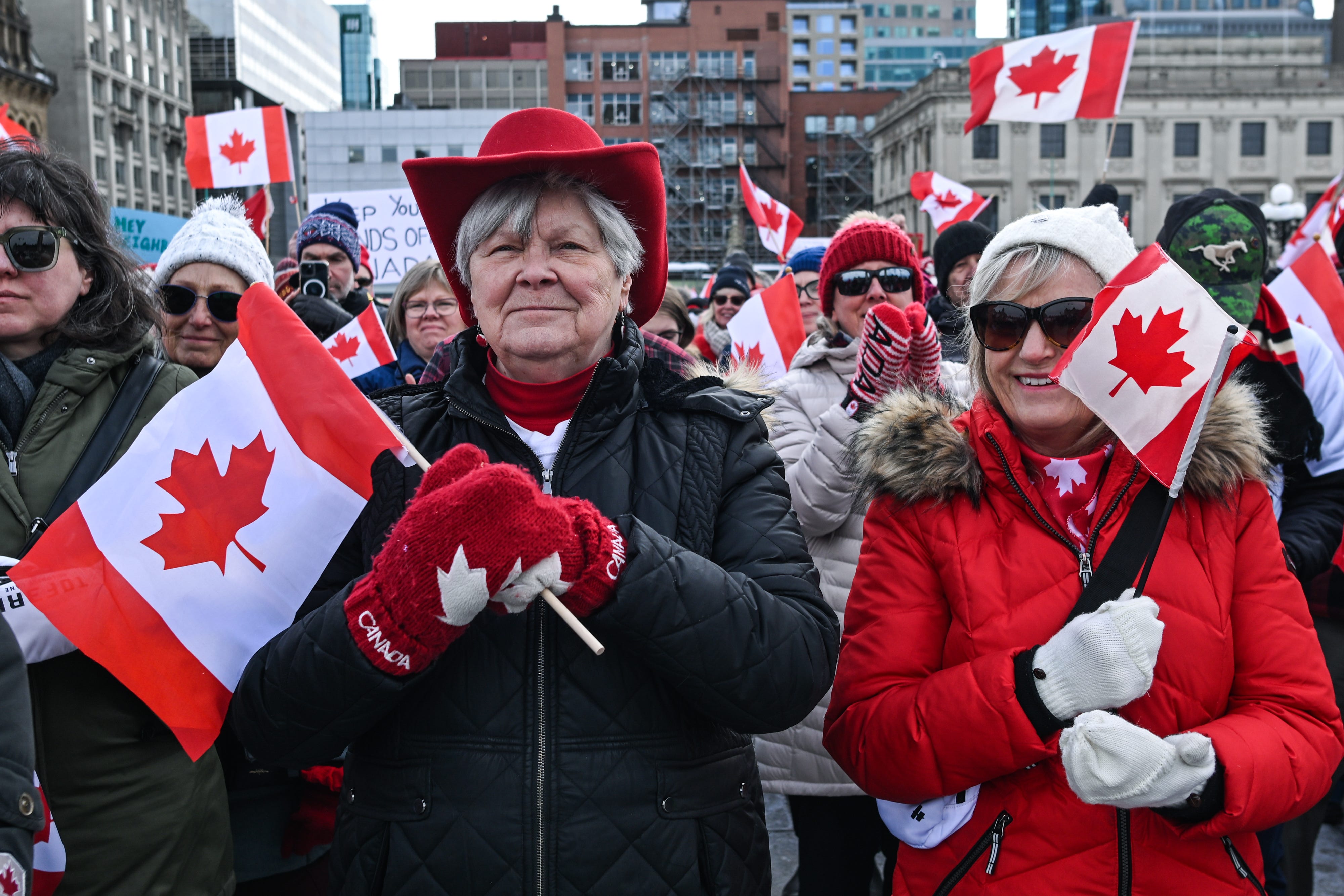 Canadians holding flags