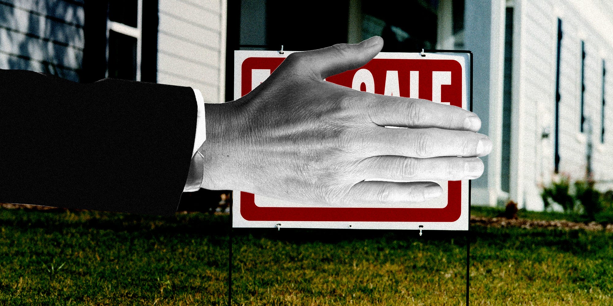 A hand covering a for sale sign.