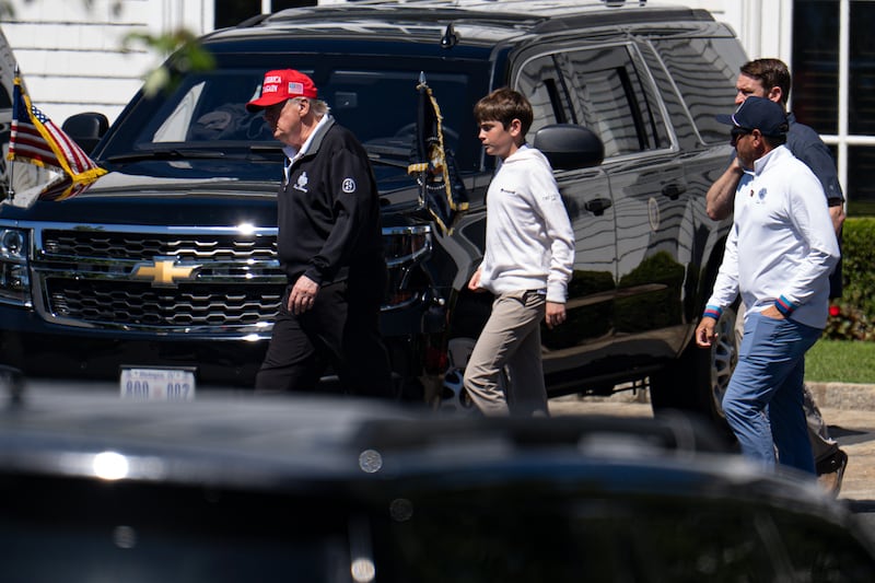 WASHINGTON, DC - AUGUST 30: U.S. President Donald Trump walks with his grandchild Spencer Trump after golfing at Trump National Golf Club on August 30, 2025 in Washington, DC. Trump is spending his Labor Day weekend in Washington, DC after deploying the National Guard to Washington this month. (Photo by Kayla Bartkowski/Getty Images)