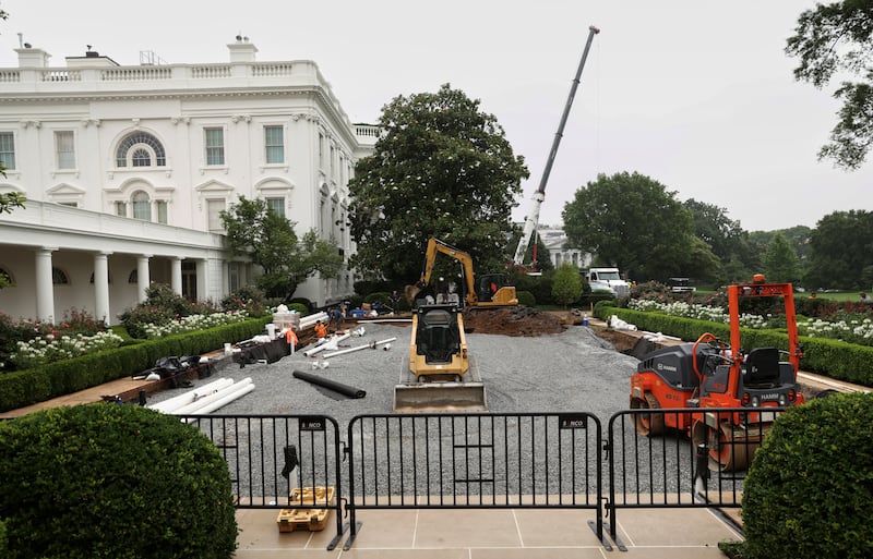 Workers reconstruct the Rose Garden from grass to pavement at White House on June 18, 2025.