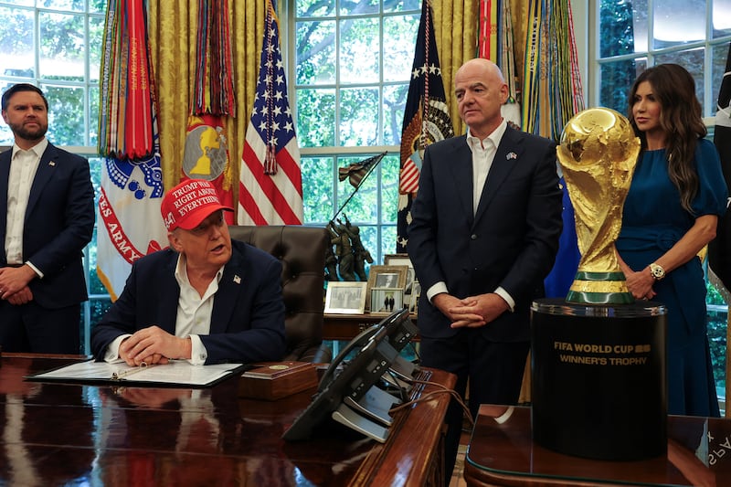 President Donald Trump largely covered his right hand with his left while speaking in the Oval Office on Friday, August 22, 2025.