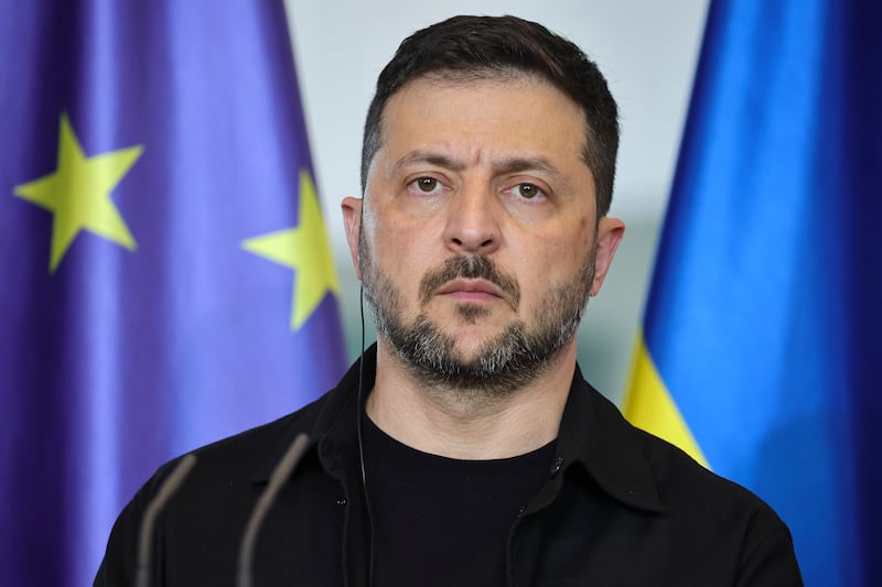 BERLIN, GERMANY - AUGUST 13: Ukrainian President Volodymyr Zelensky listens as German Chancellor Friedrich Merz (not pictured) speaks during a joint press conference at the Chancellery following a virtual meeting hosted by Merz between European leaders and U.S. President Donald Trump on August 13, 2025 in Berlin, Germany. The meeting was meant to clarify the European position prior to talks scheduled for Friday between Trump and Russian President Vladimir Putin in Alaska on reaching an end to the Russian war in Ukraine. (Photo by Omer Messinger/Getty Images)