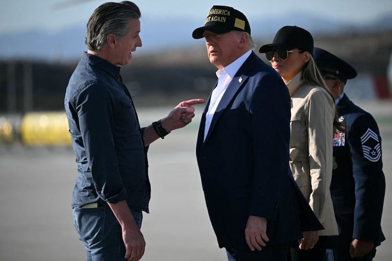 US President Donald Trump and First Lady Melania Trump are greeted by California Governor Gavin Newsom upon arrival at Los Angeles International Airport in Los Angeles, California, on January 24, 2025, to visit the region devastated by the Palisades and Eaton fires. (Photo by Mandel NGAN / AFP) (Photo by MANDEL NGAN/AFP via Getty Images)