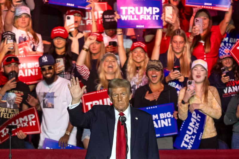 Donald Trump waves at supporters during a campaign rally at First Horizon Coliseum in Greensboro, North Carolina, on November 2, 2024.