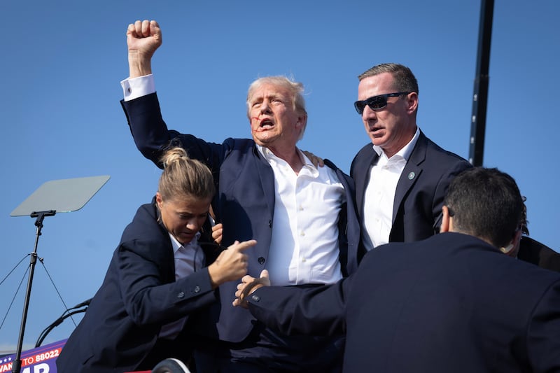 BUTLER, PENNSYLVANIA - JULY 13: Republican presidential candidate former President Donald Trump defiantly pumps his fist after being shot and rushed offstage during a rally on July 13, 2024 in Butler, Pennsylvania. Butler County district attorney Richard Goldinger said the gunman was shot and killed after injuring former U.S. President Donald Trump, killing one audience member and critically injuring two others in the shooting. (Photo by Anna Moneymaker/Getty Images)